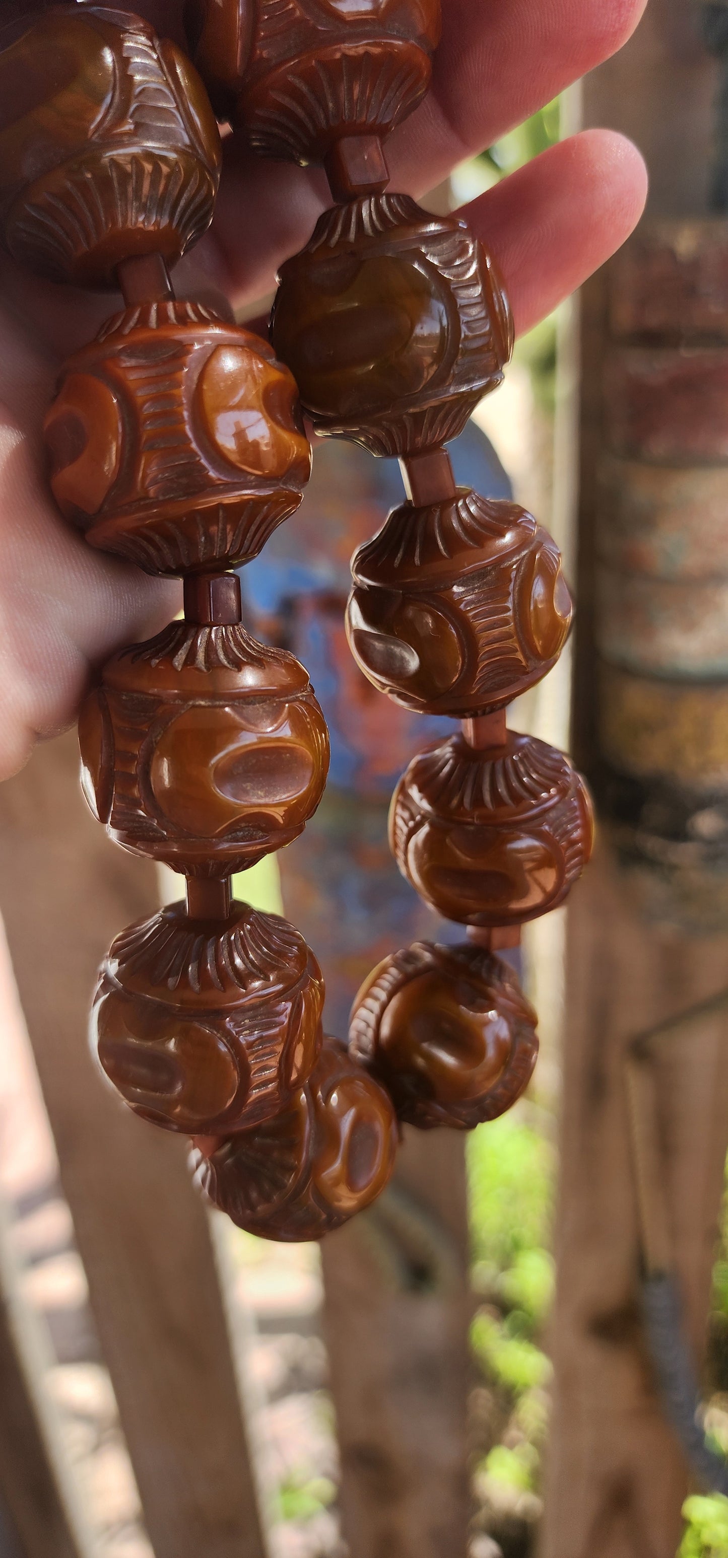 An extraordinary Art Deco-era 1920s carved Bakelite beaded choker necklace that embodies the bold glamour of its age.