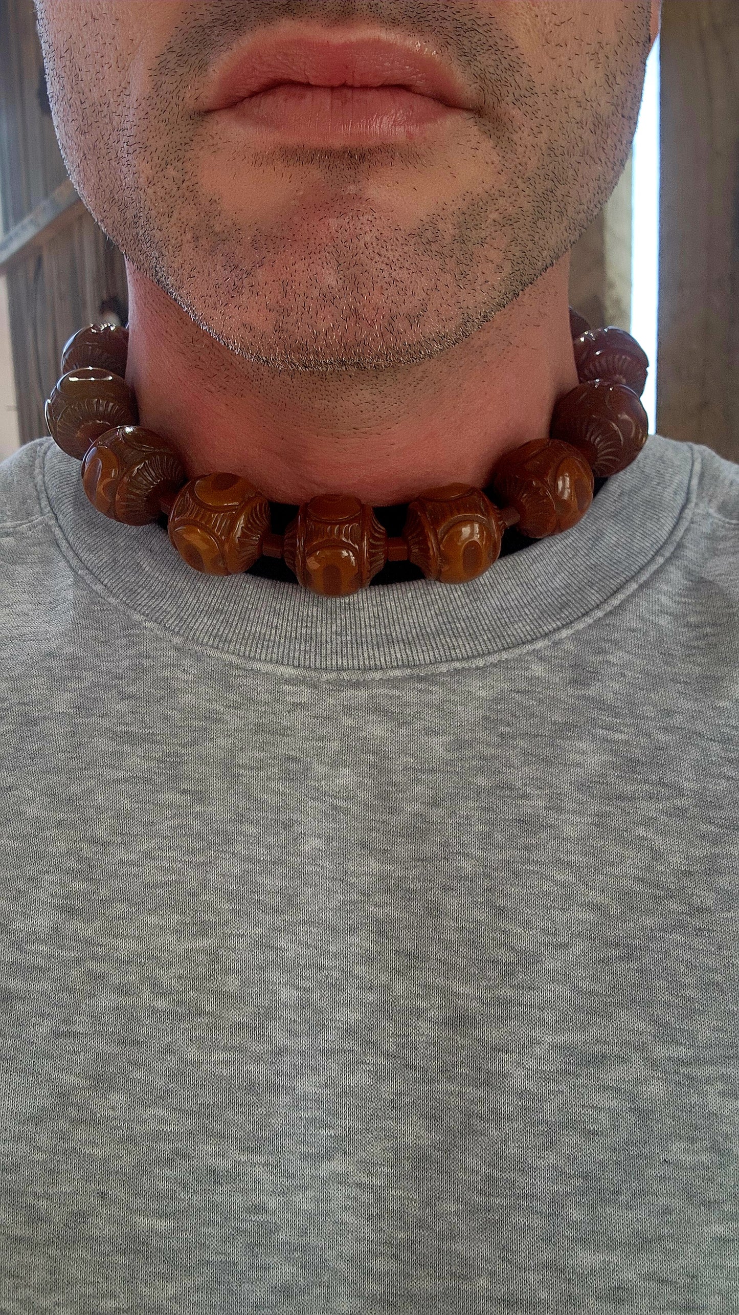 An extraordinary Art Deco-era 1920s carved Bakelite beaded choker necklace that embodies the bold glamour of its age.