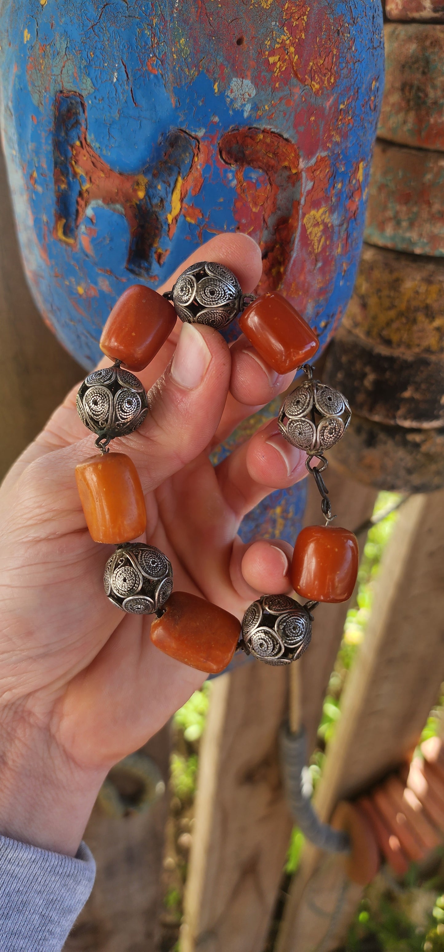 A striking and authentic example of North African Berber adornment, this bracelet is crafted with alternating chunky African amber beads and handmade sterling silver filigree spheres.