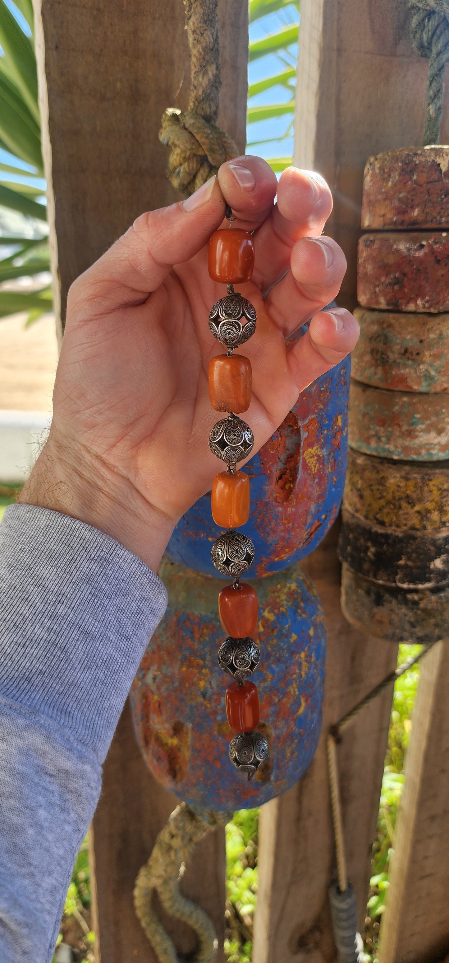 A striking and authentic example of North African Berber adornment, this bracelet is crafted with alternating chunky African amber beads and handmade sterling silver filigree spheres.