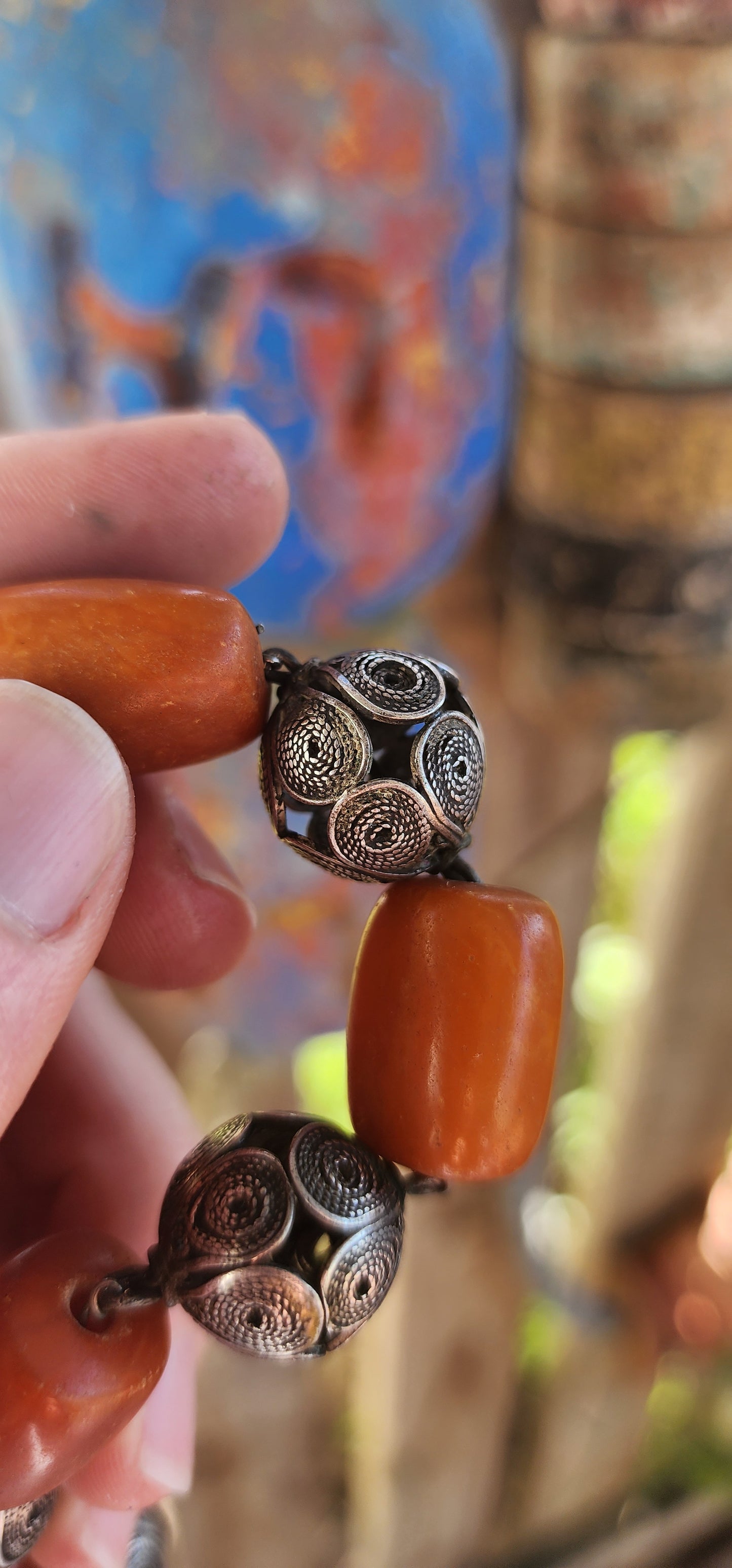 A striking and authentic example of North African Berber adornment, this bracelet is crafted with alternating chunky African amber beads and handmade sterling silver filigree spheres.