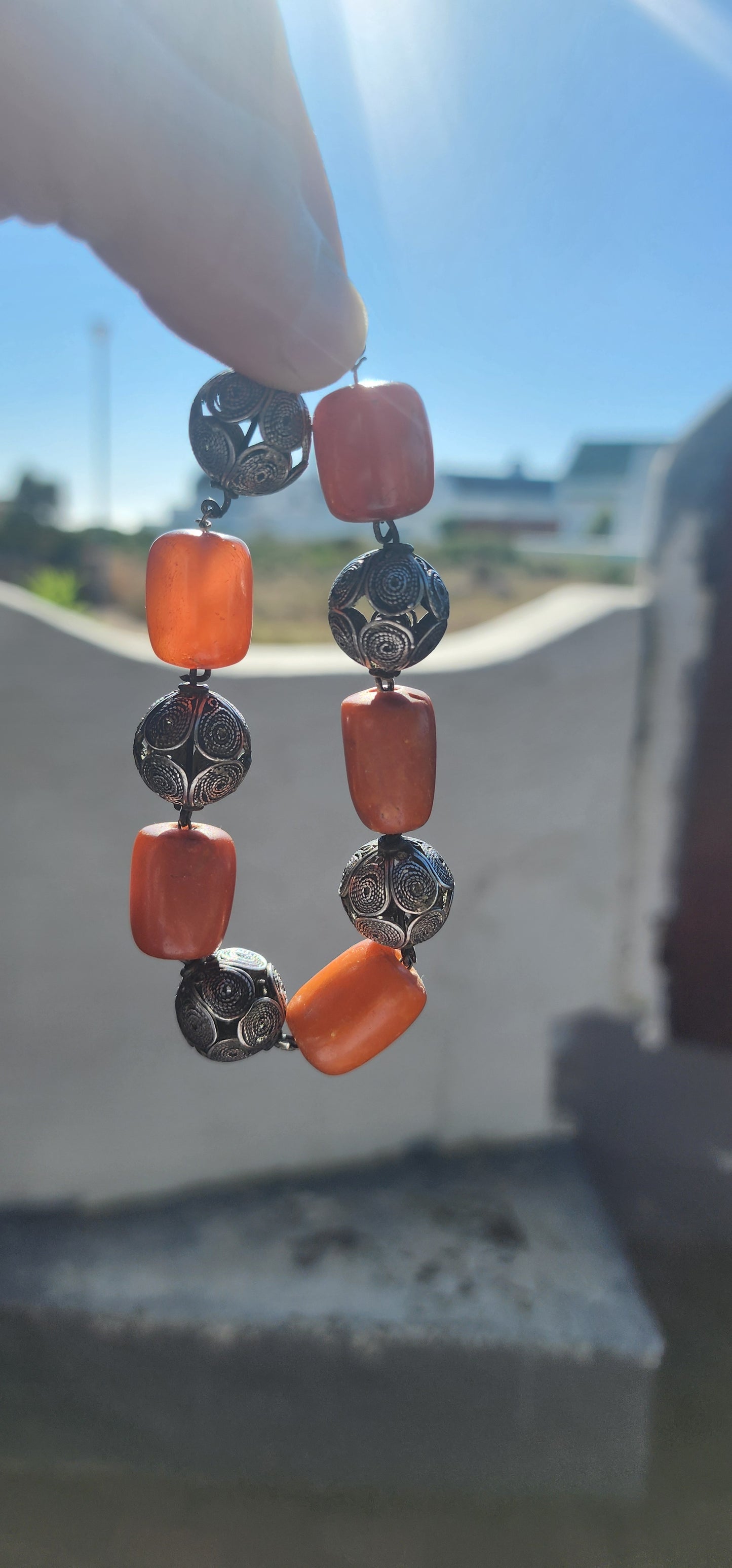 A striking and authentic example of North African Berber adornment, this bracelet is crafted with alternating chunky African amber beads and handmade sterling silver filigree spheres.