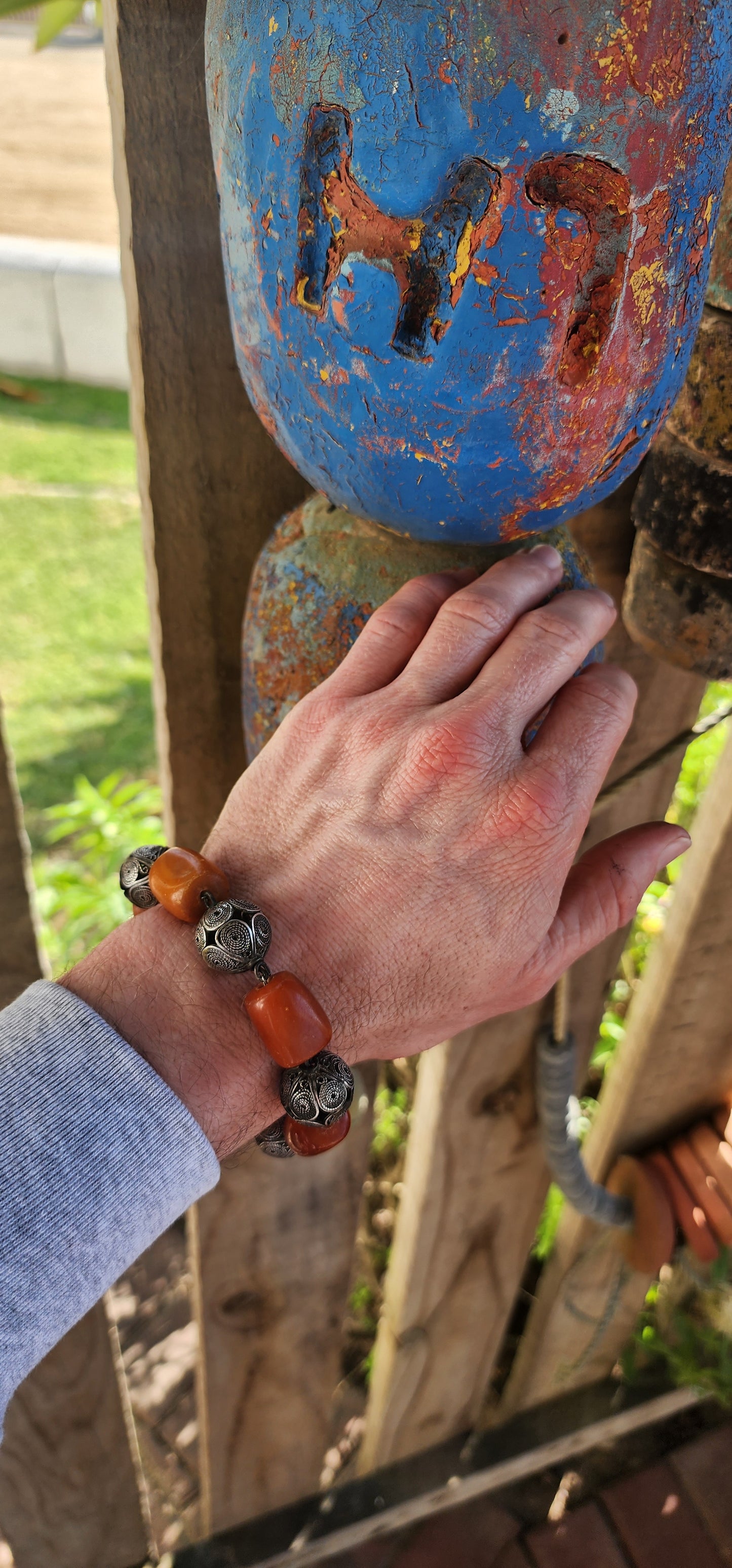 A striking and authentic example of North African Berber adornment, this bracelet is crafted with alternating chunky African amber beads and handmade sterling silver filigree spheres.