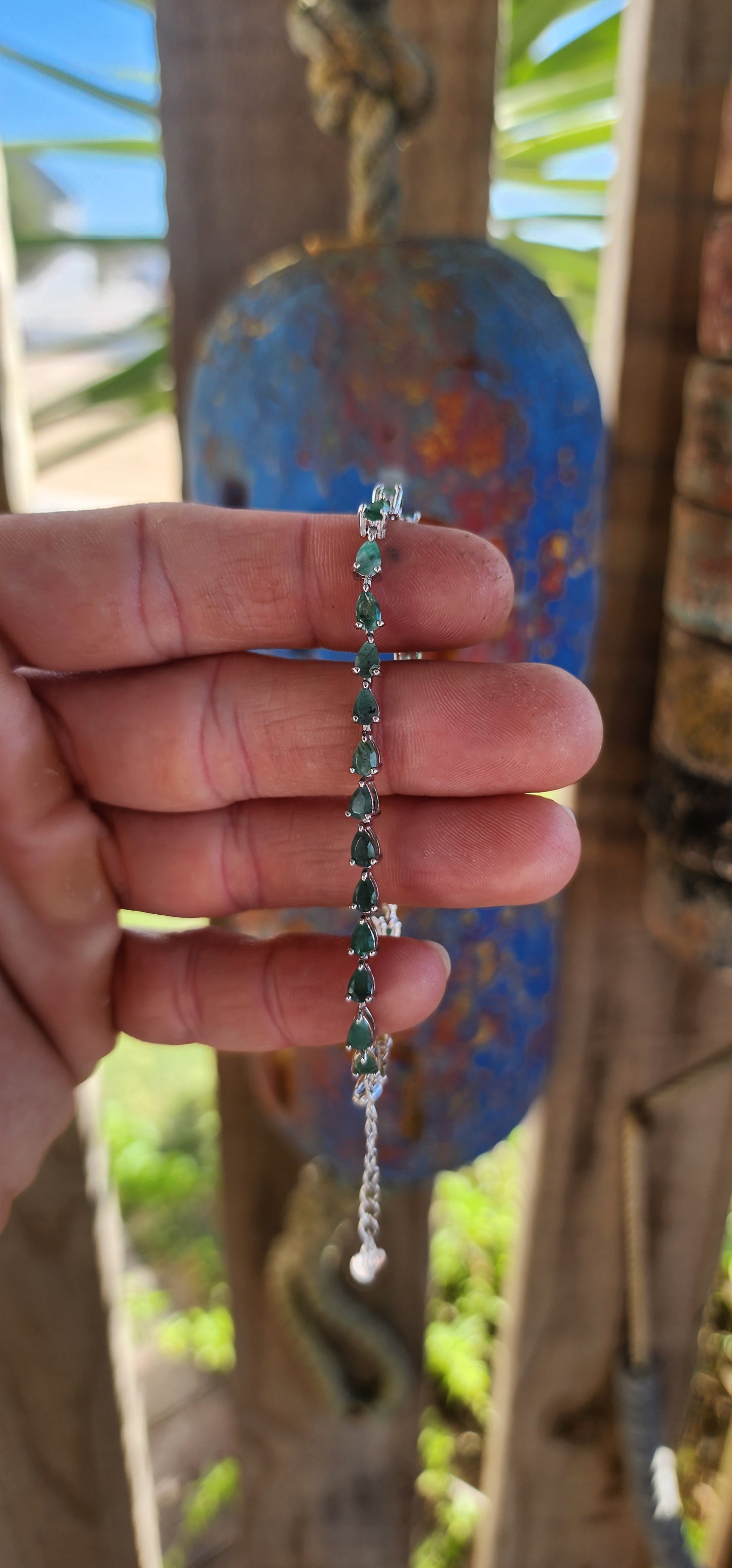 Up for grabs is this magnificent sterling silver unisex tennis bracelet, set with a striking line of 27 pear-cut emerald gemstones.