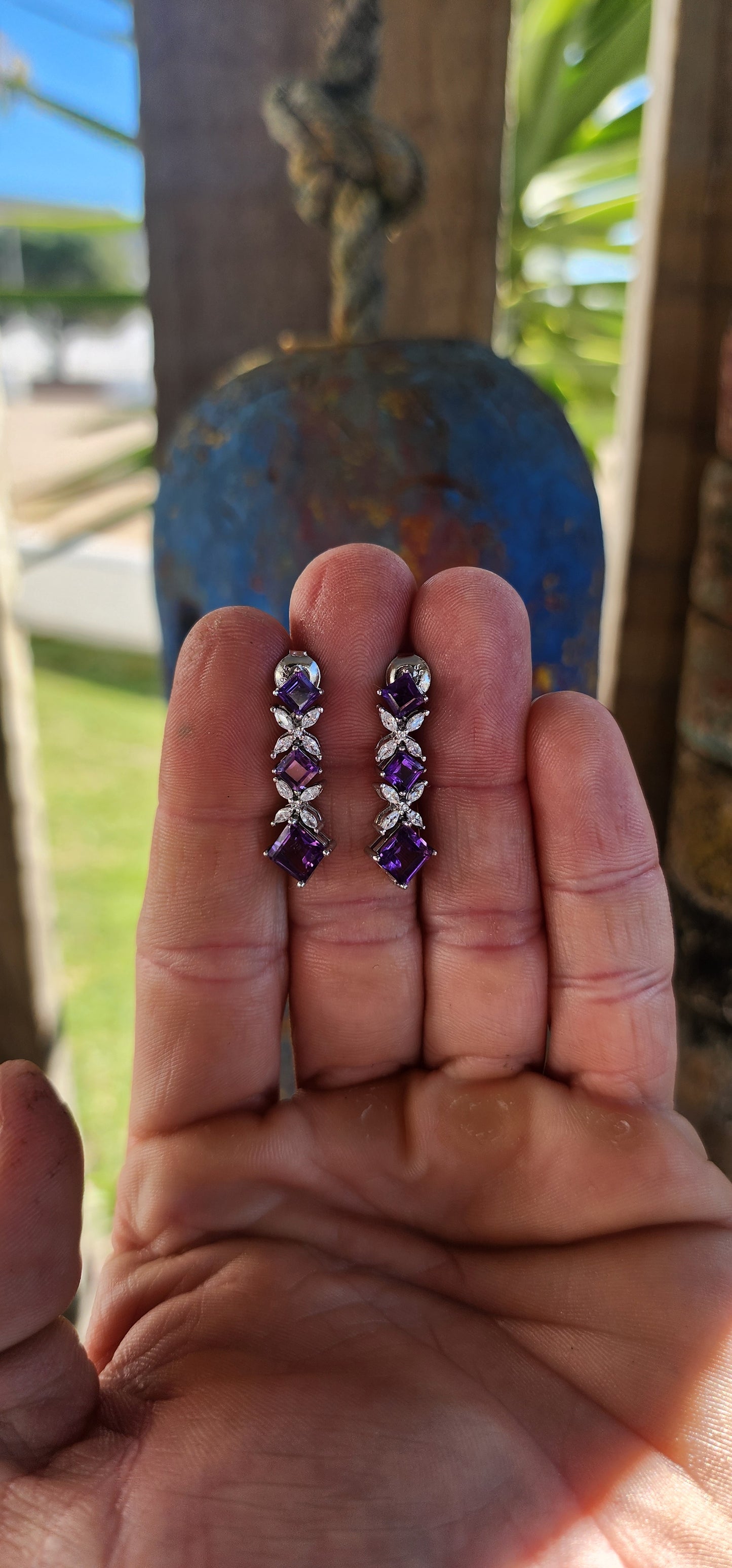 An enchanting pair of floral-inspired articulated drop earrings, crafted in radiant sterling silver.