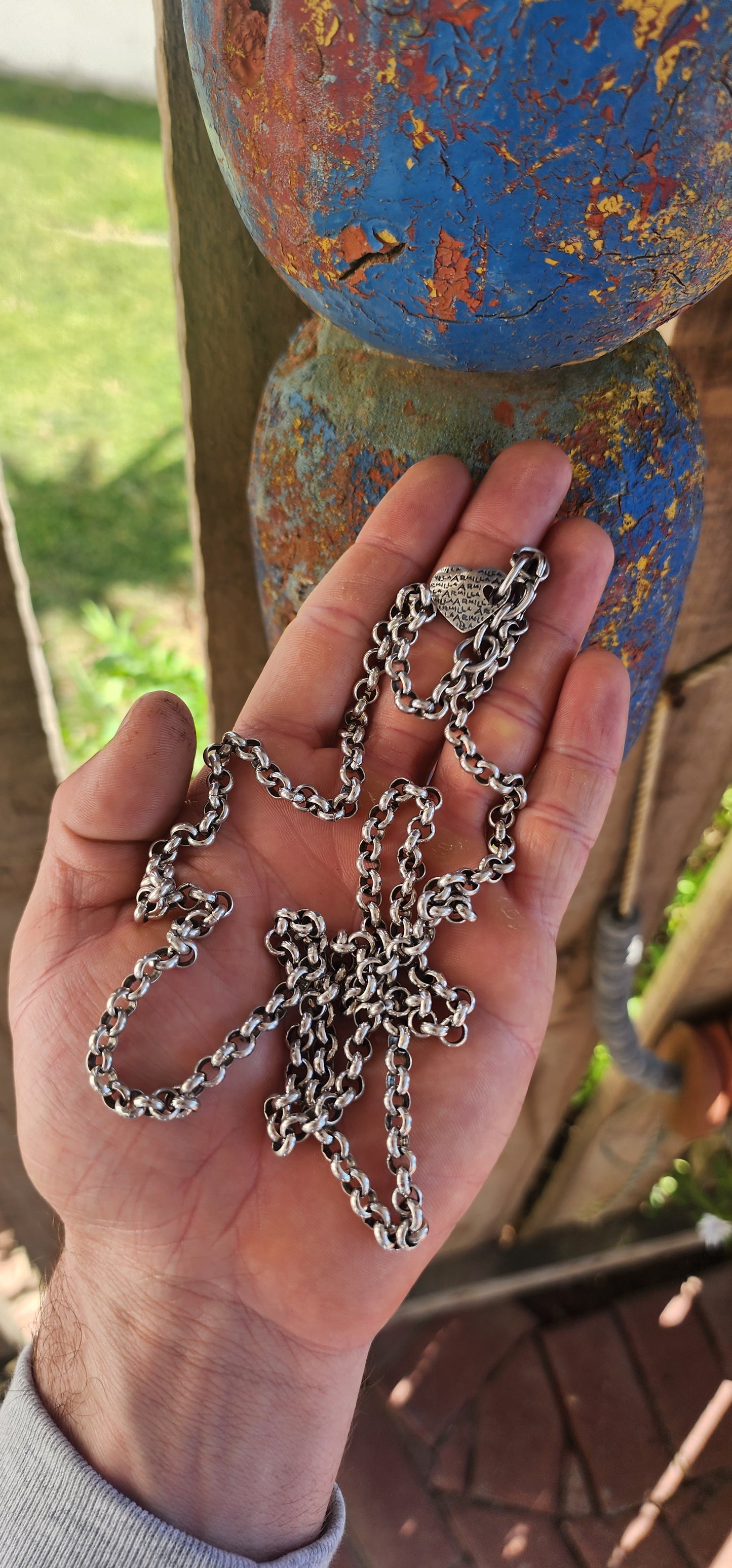 Up for grabs is this extra-length silver-plated rolo link necklace, an early creation by the renowned local designer Armilla.