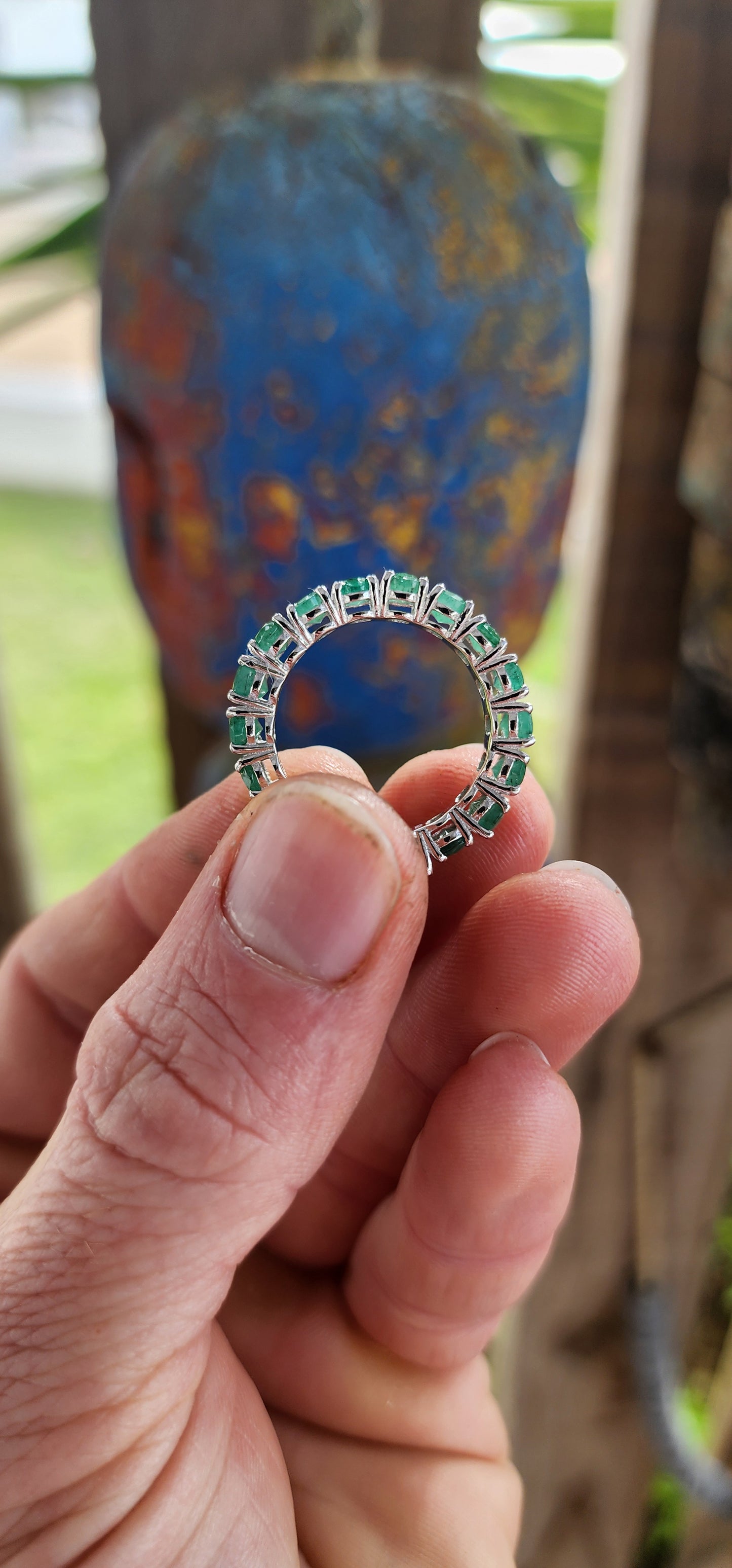 This glorious unisex sterling silver full eternity ring is a never-ending parade of 18 glowing oval-cut emeralds.