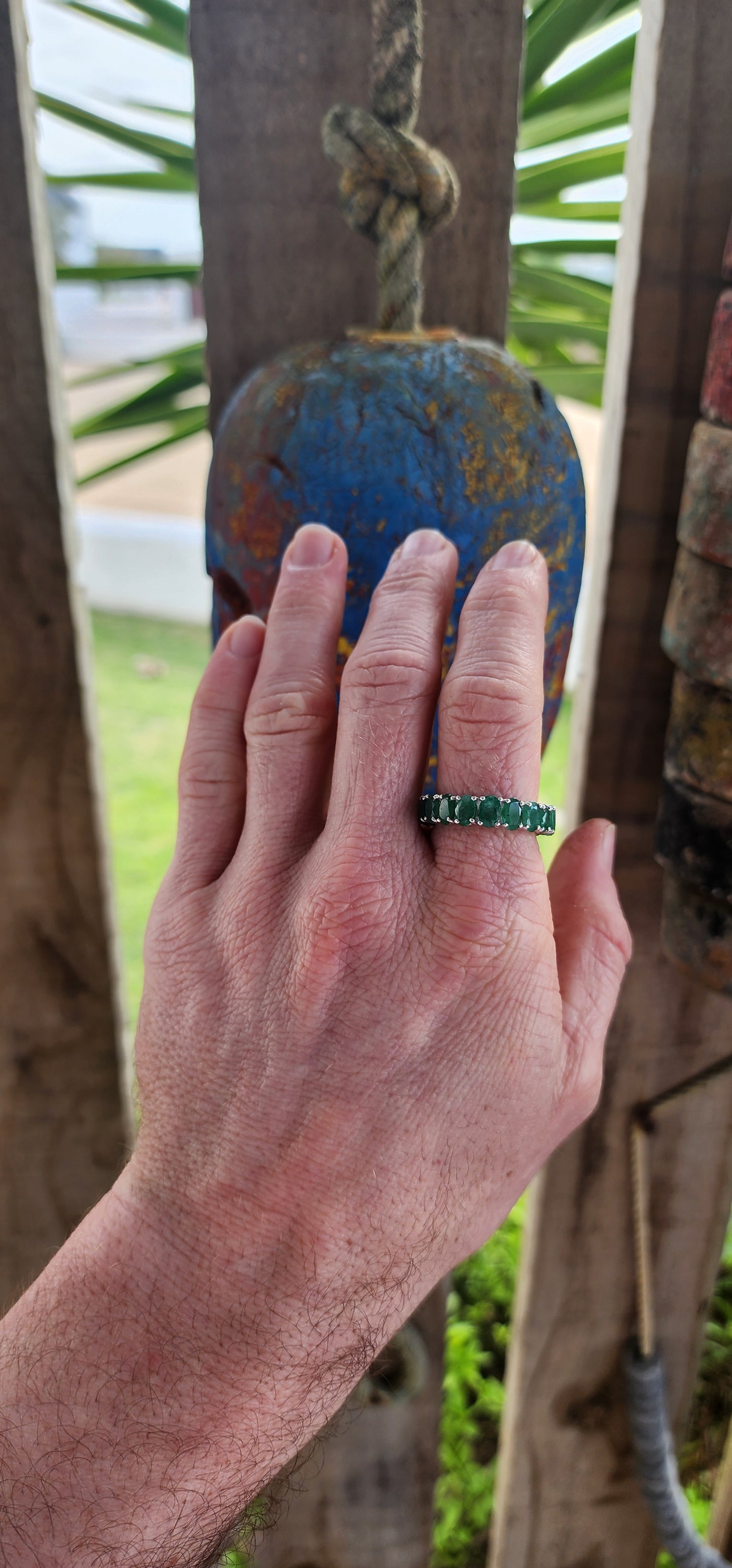 This glorious unisex sterling silver full eternity ring is a never-ending parade of 18 glowing oval-cut emeralds.