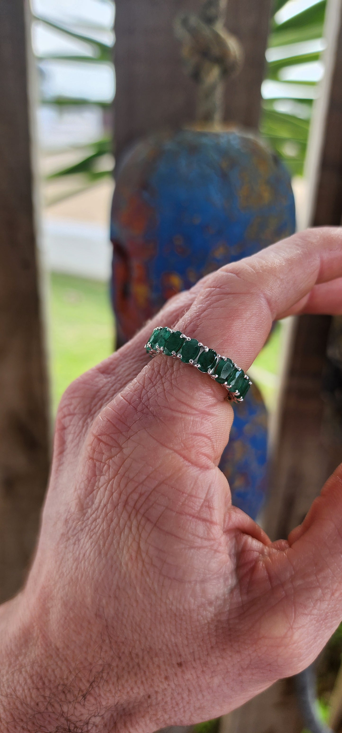 This glorious unisex sterling silver full eternity ring is a never-ending parade of 18 glowing oval-cut emeralds.