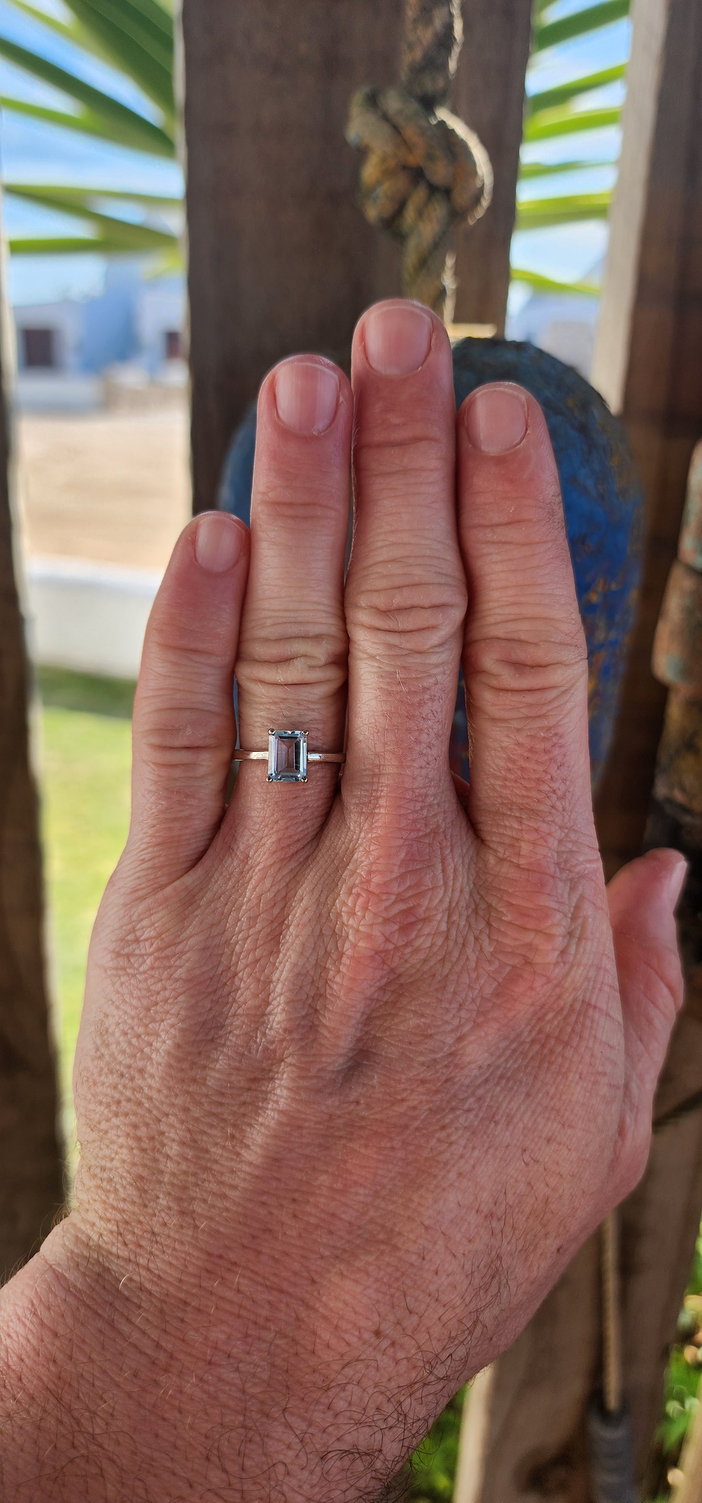 Beautifully crafted sterling silver solitaire ring.
At its heart lies a captivating emerald-cut sky blue topaz, held securely in a four-prong raised basket.
