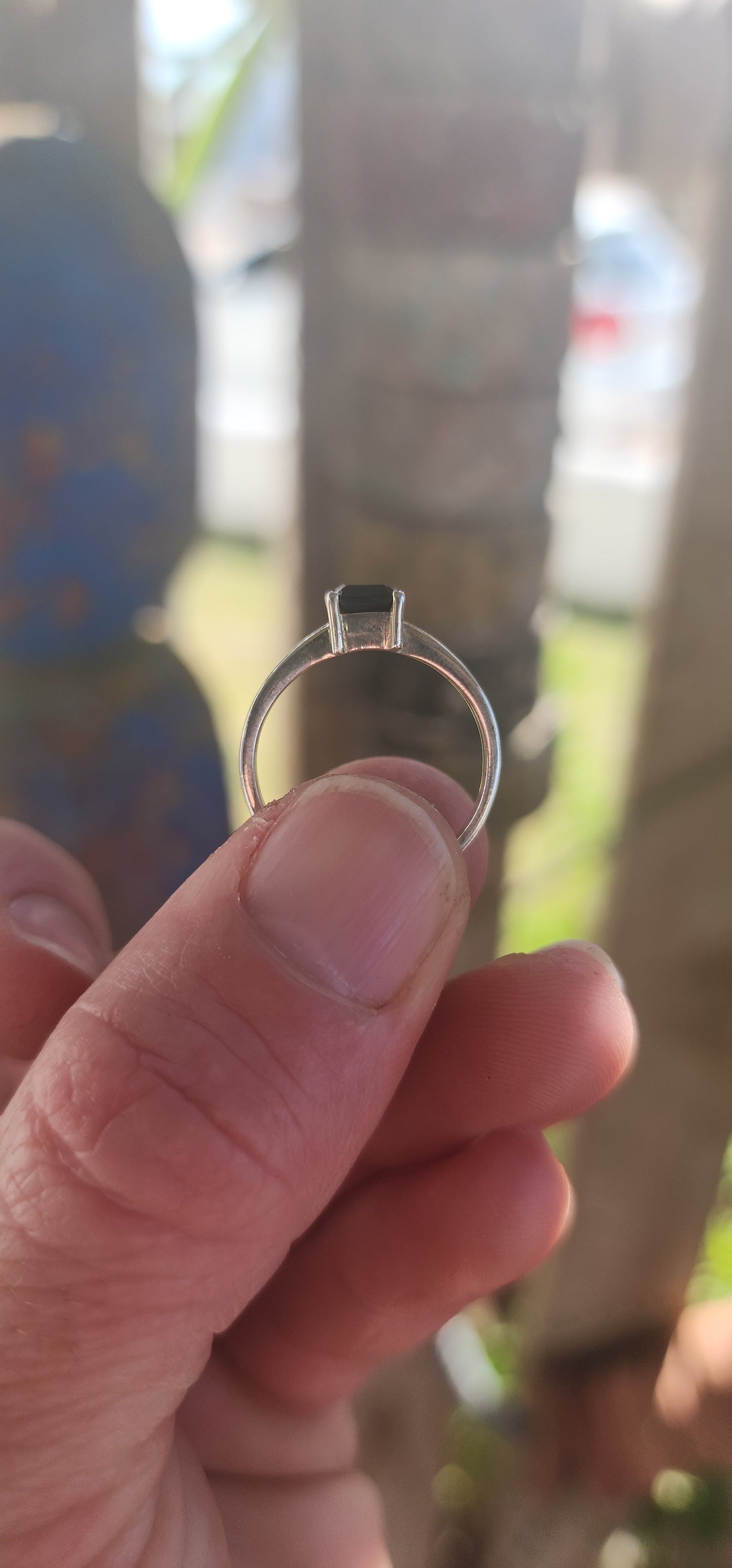 This striking sterling silver solitaire ring showcases a bold emerald-cut black onyx, elevated proudly in a sleek prong-set basket.