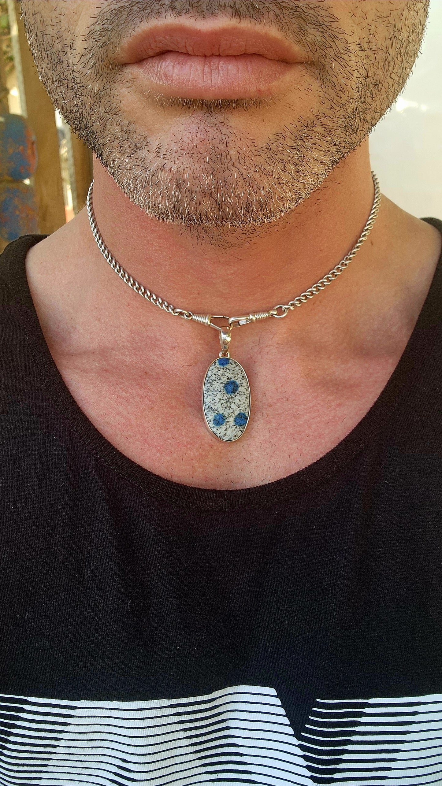 Beautiful sterling silver pendant featuring an oval-shaped rare K2 Jasper cabochon, securely tube-set in a sleek, modern silver frame.