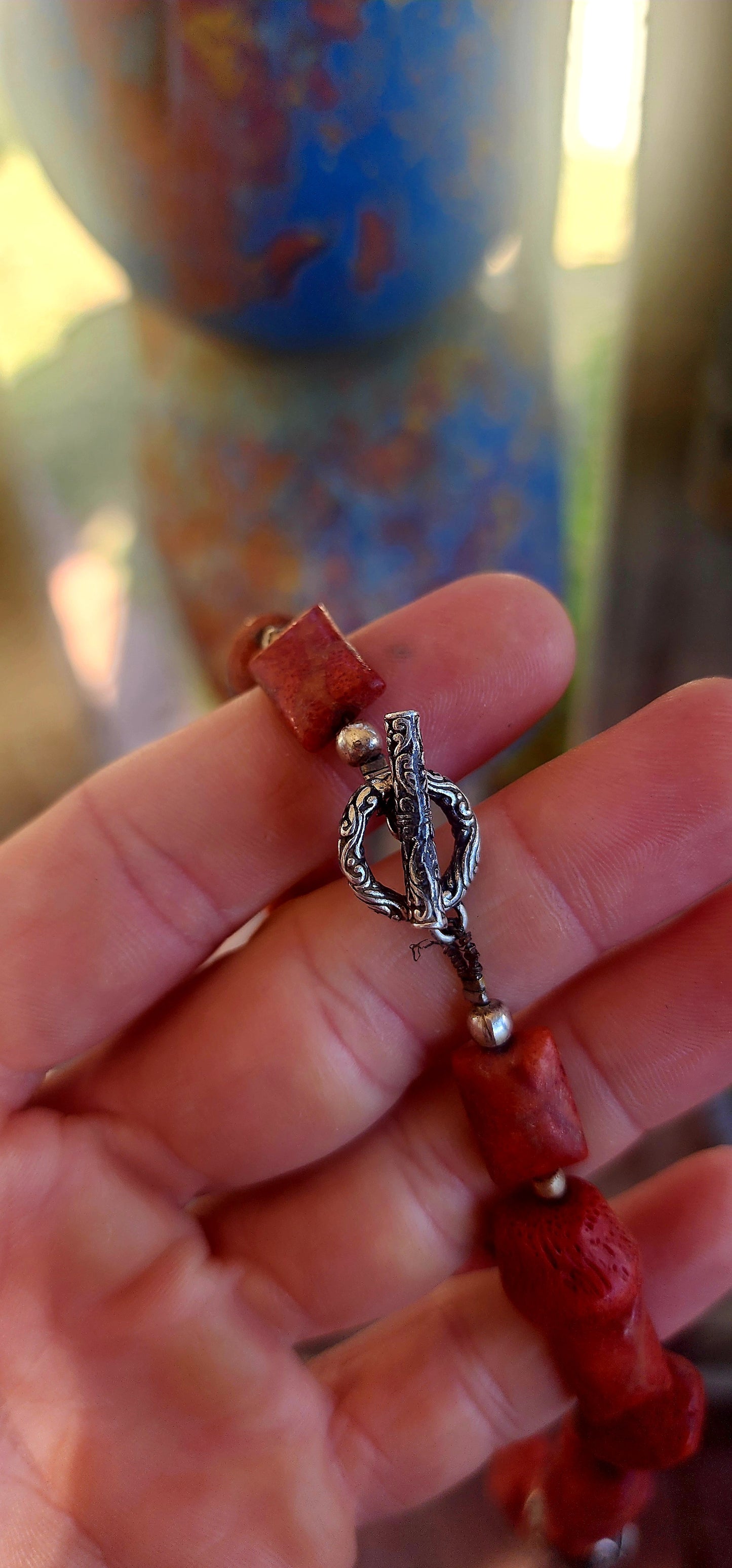 This chunky artisan-made necklace is crafted in solid sterling silver and strung with beautifully irregular, semi-polished natural Mediterranean coral beads.