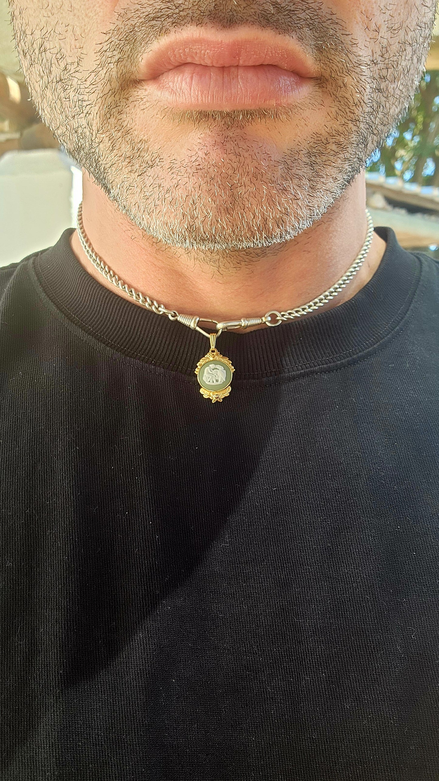 This beautiful vintage 1980s pendant features an authentic Wedgwood jasperware panel, set within an ornate yellow gold-plated frame that gives it a rich, regal presence.