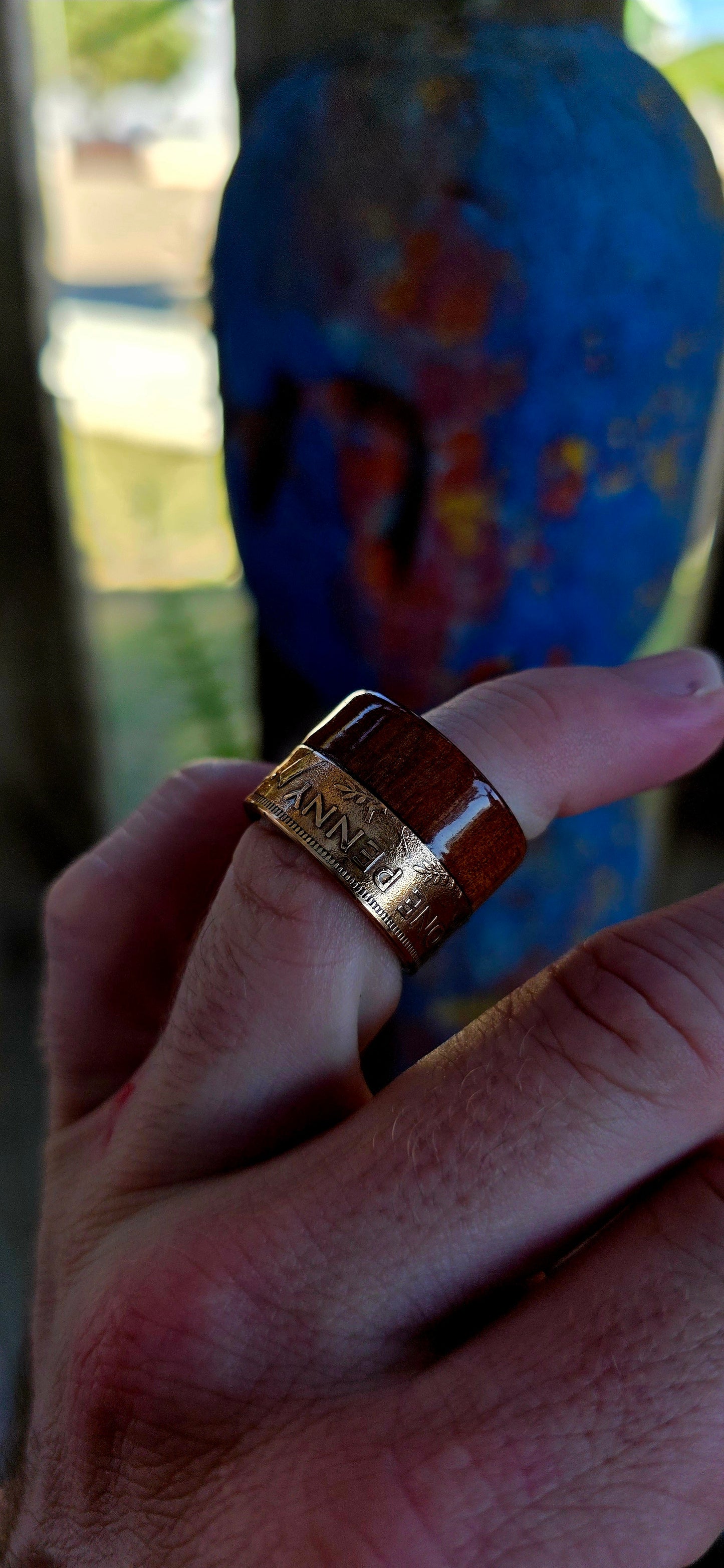This striking extra-wide artisan statement ring combines natural materials with historic coinage, resulting in a piece that feels earthy and adventurous — the kind of ring that looks like it belongs on a treasure hunter’s hand.