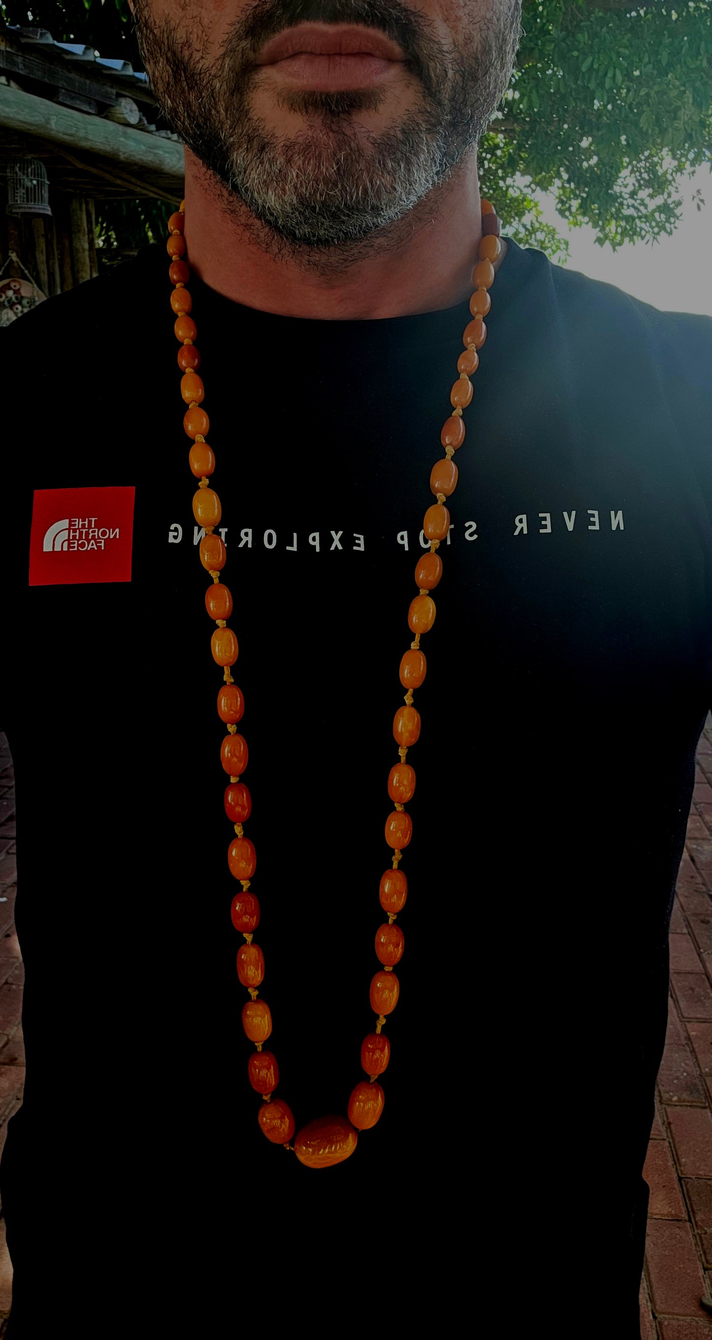 An extra-length antique Baltic amber necklace, showcasing a luxurious strand of butterscotch amber beads in beautifully graduated oval forms.