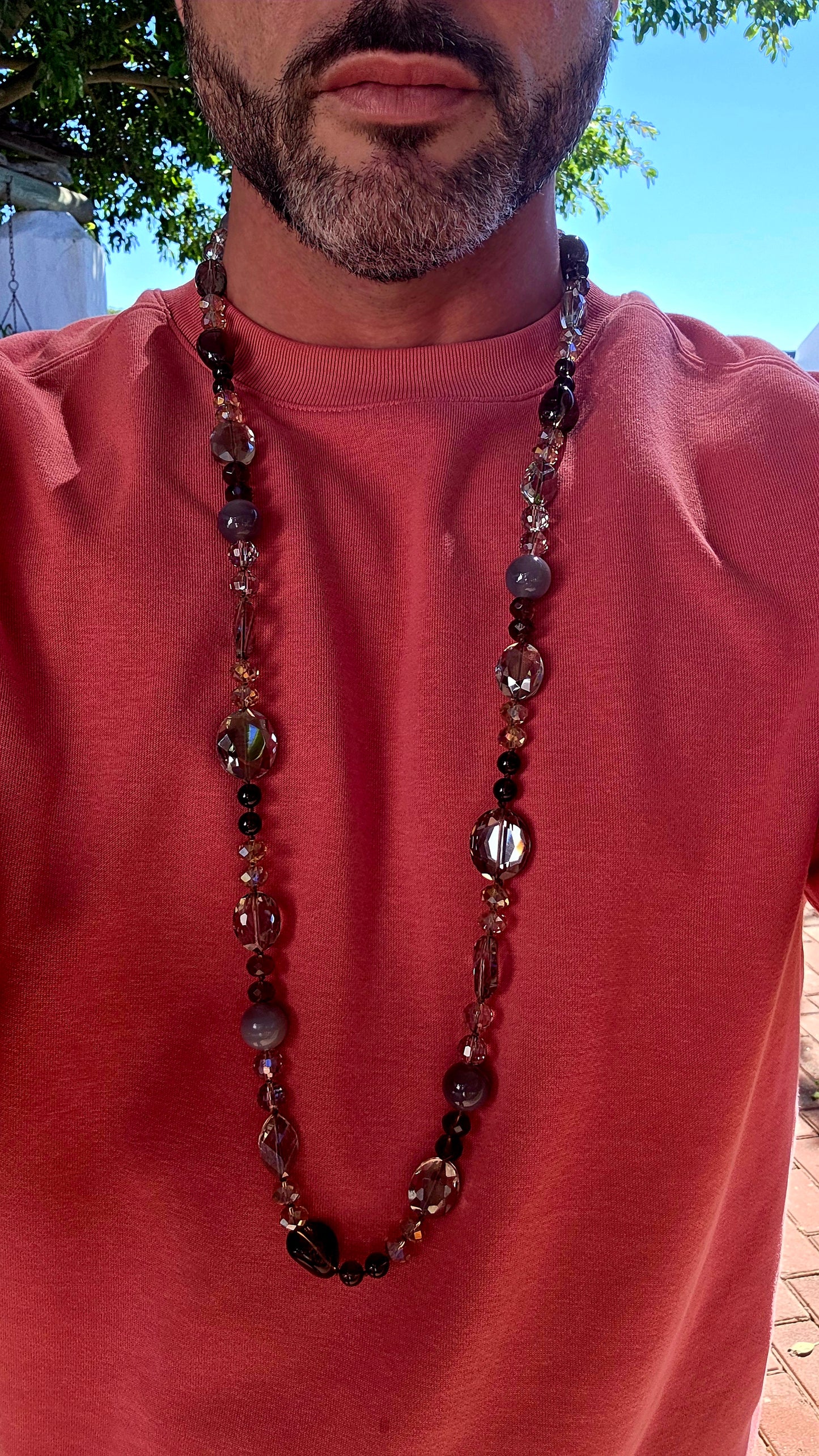 A chunky, extra-length, claspless statement necklace featuring a dazzling mix of Swarovski crystal beads and natural gemstones — bold, fluid, and absolutely dripping in sparkle.