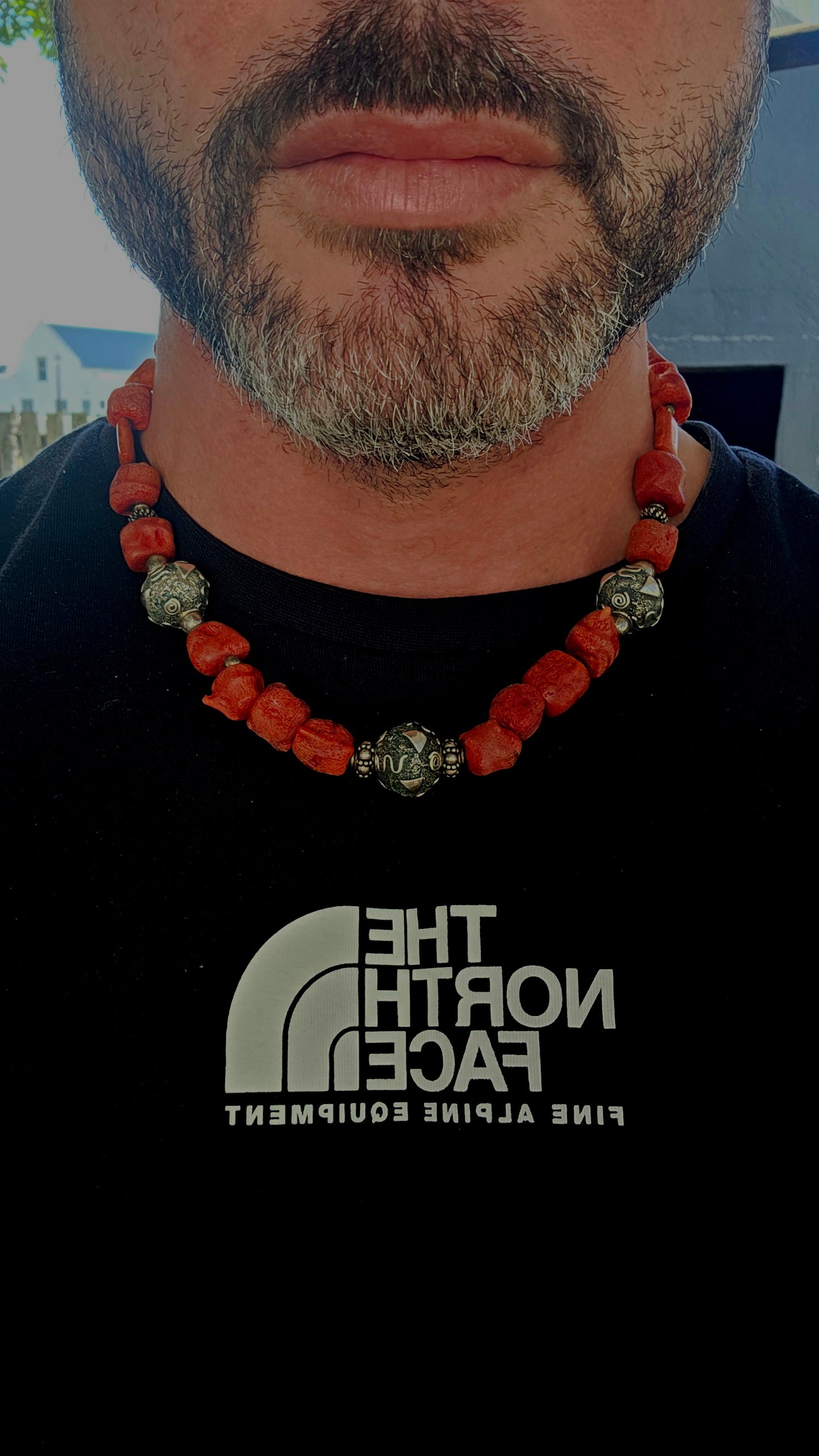 This chunky artisan-made necklace is crafted in solid sterling silver and strung with beautifully irregular, semi-polished natural Mediterranean coral beads.