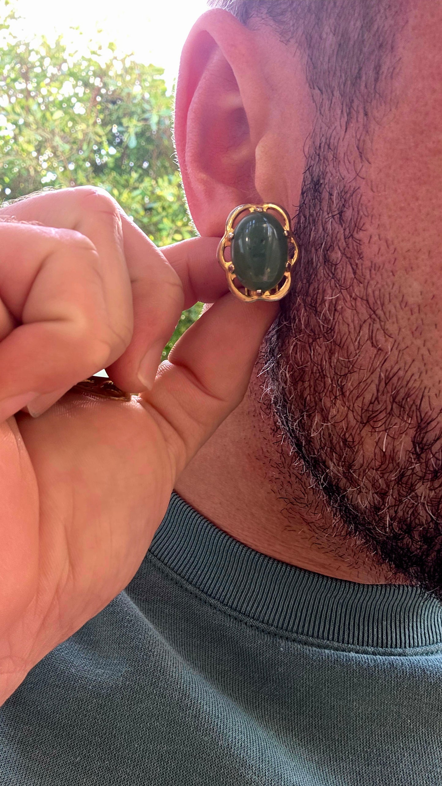 Beautiful pair of vintage designer clip-on earrings crafted in rich yellow gold-filled metal and prong set with glowing oval-shaped Nephrite Jade cabochons in the highly sought-after “Spinach Jade” variety.