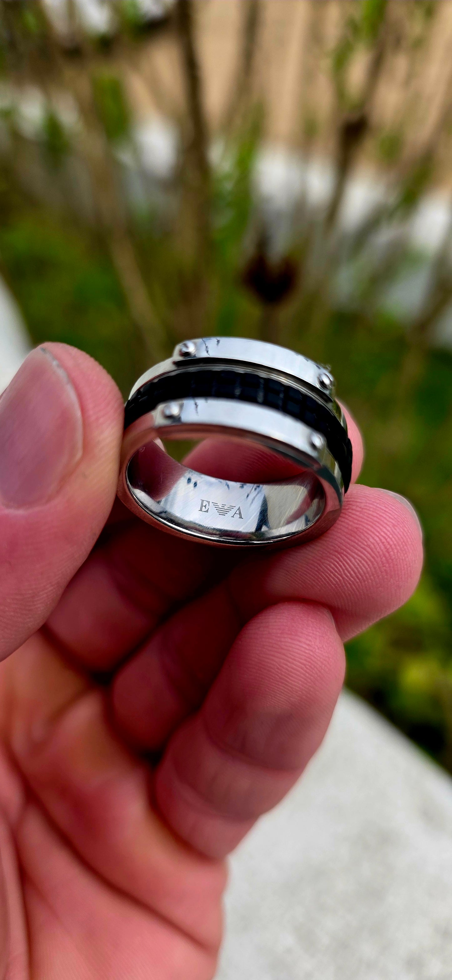 Bold, masculine, and contemporary... this chunky designer ring by Emporio Armani perfectly captures the sleek industrial aesthetic that has become synonymous with the brand's modern menswear collections.