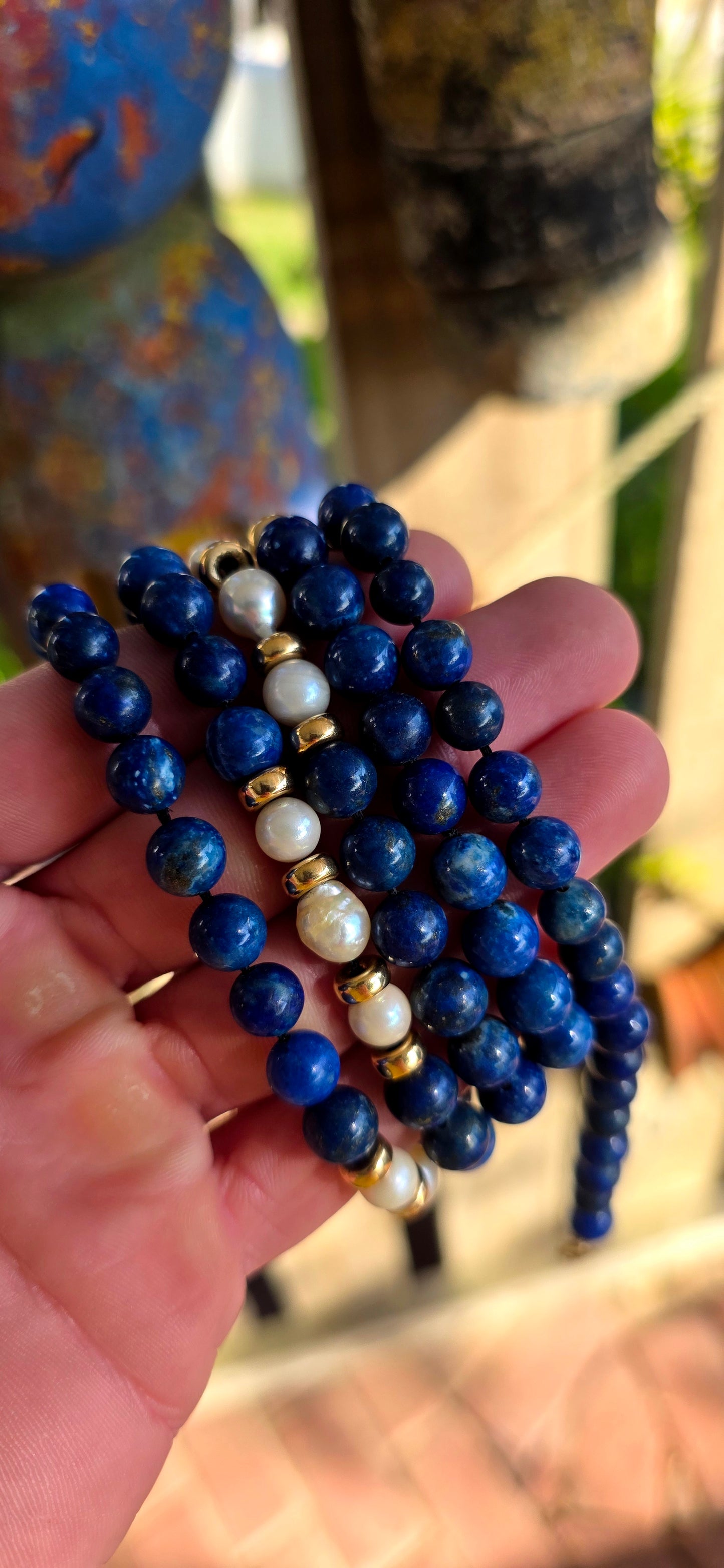 A striking statement piece that combines the rich blues of ancient royalty with the elegance of pearls and gold.