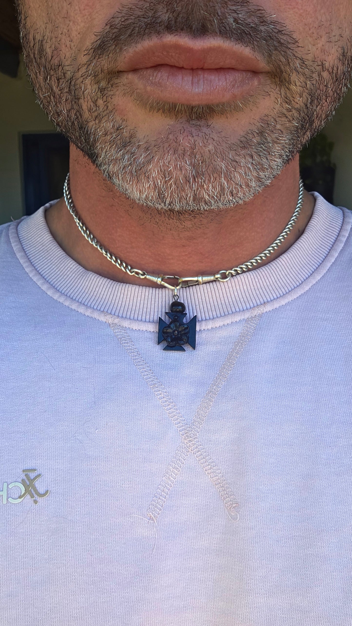 A wonderfully unusual little survivor from the Victorian era — an antique hand-carved Whitby jet pendant/charm, beautifully fashioned into the distinctive form of a Maltese cross.