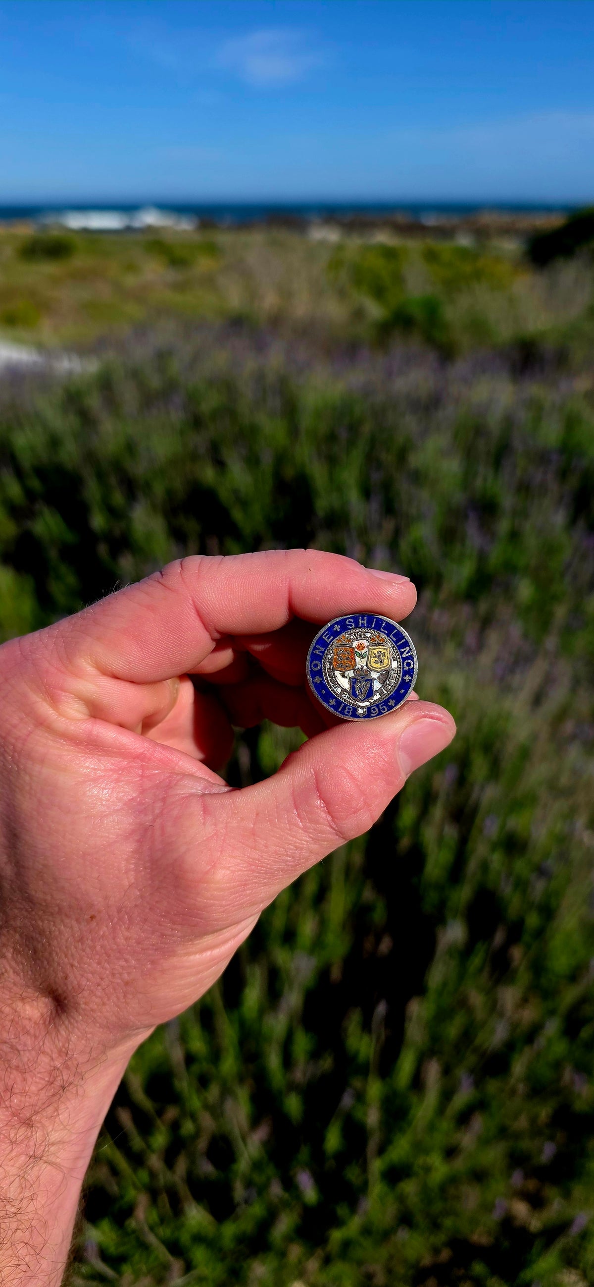 An antique 1895 British Sterling Silver One Shilling coin, beautifully transformed into a colourful enamelled sweetheart / love token.