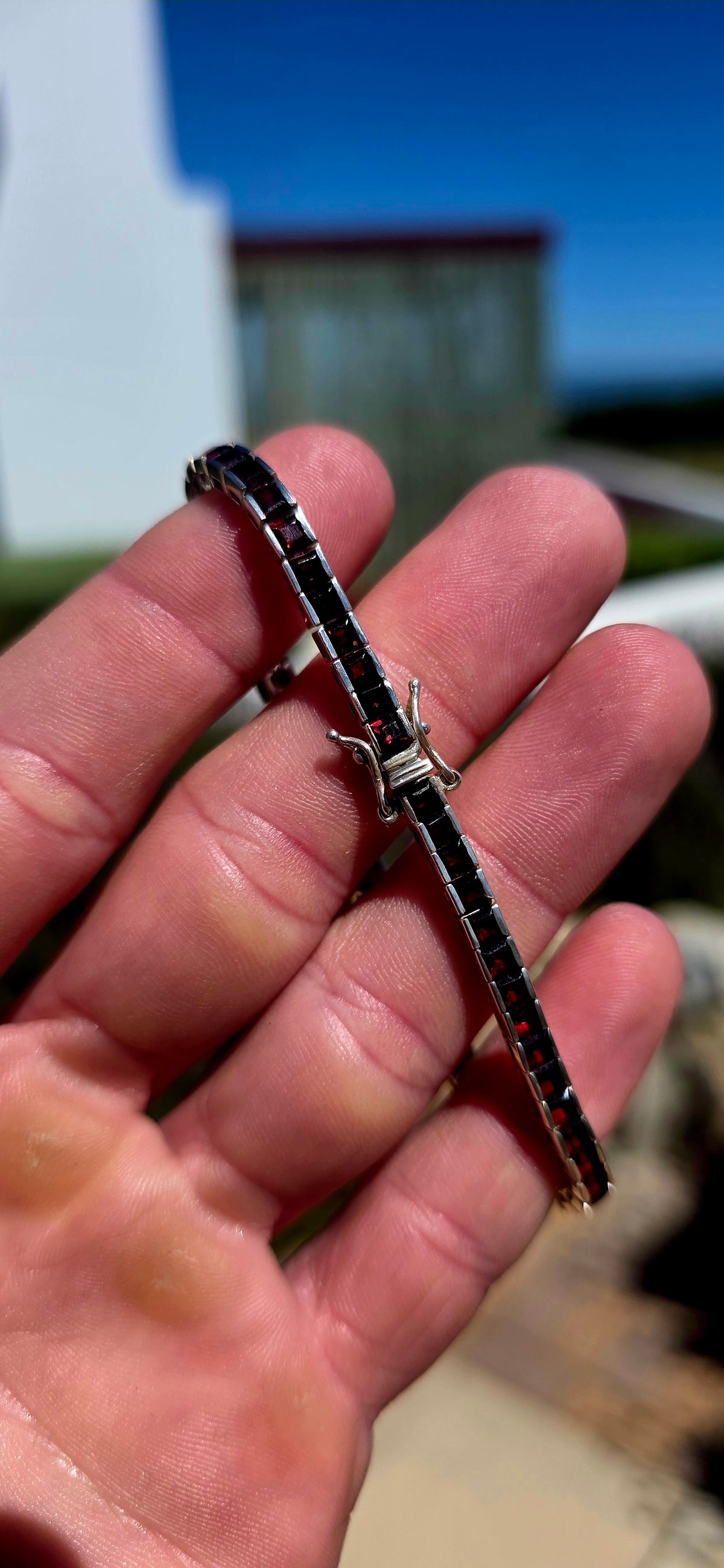 A wonderfully sleek vintage UNISEX sterling silver tennis bracelet, completely set with an impressive 56 deep-red garnets.