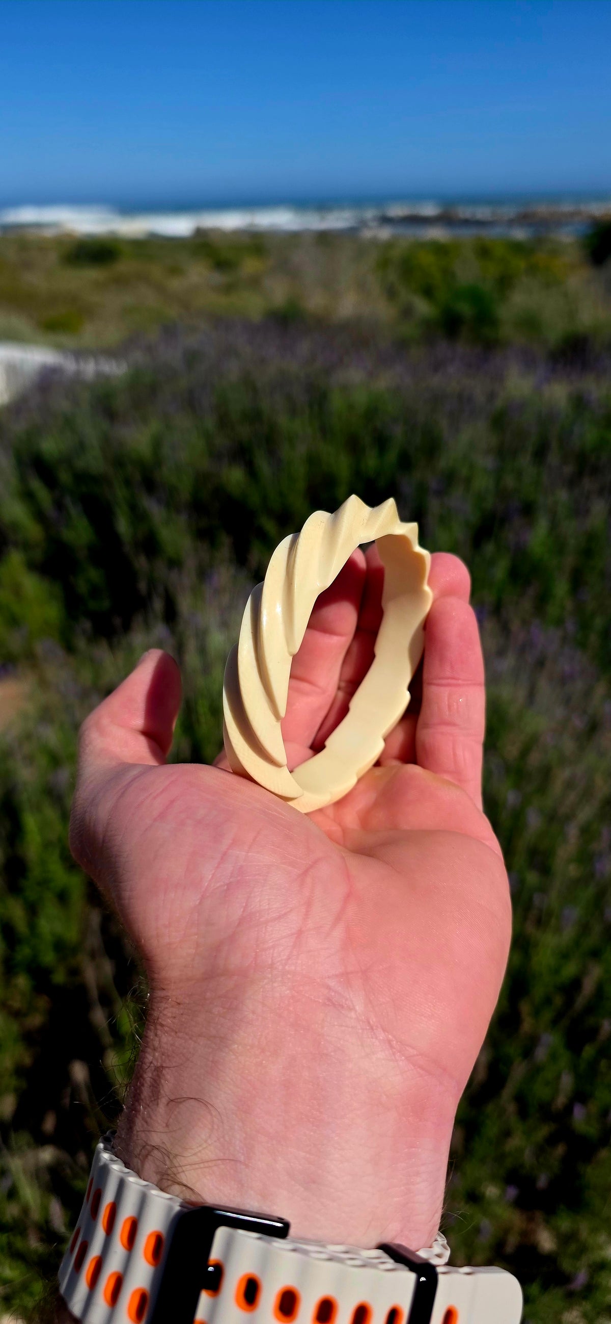 This substantial pre-ban ivory bangle has been expertly hand-carved from a single piece of ivory into a fabulous continuous twisted spiral design, creating the illusion of overlapping ribbons wrapping around the wrist.