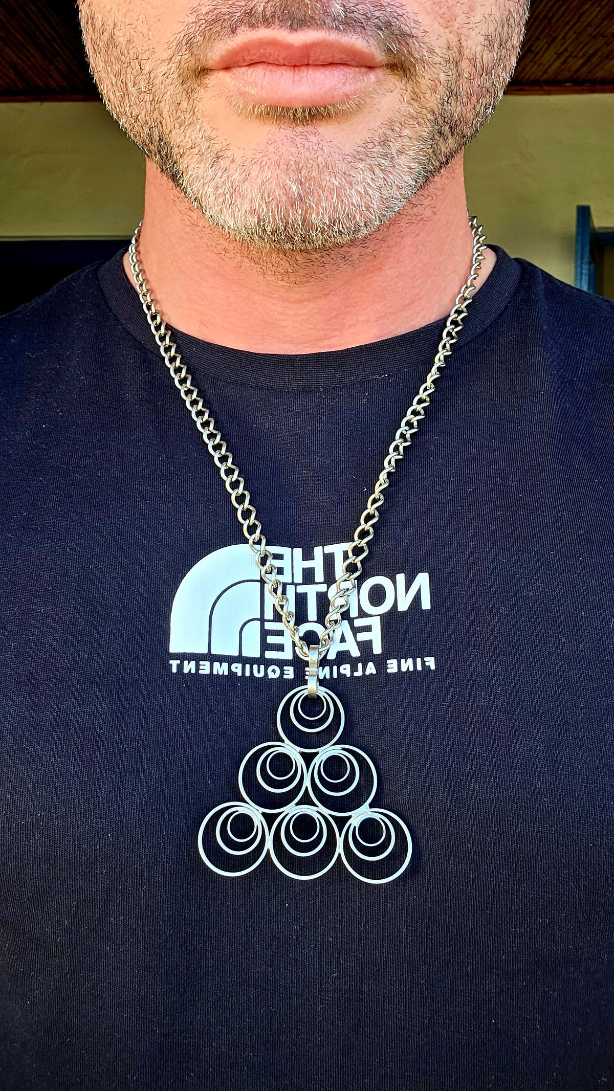 A striking vintage modernist studio-made necklace, featuring a generously sized, sculptural silvertone pendant suspended from an extra-length chain!