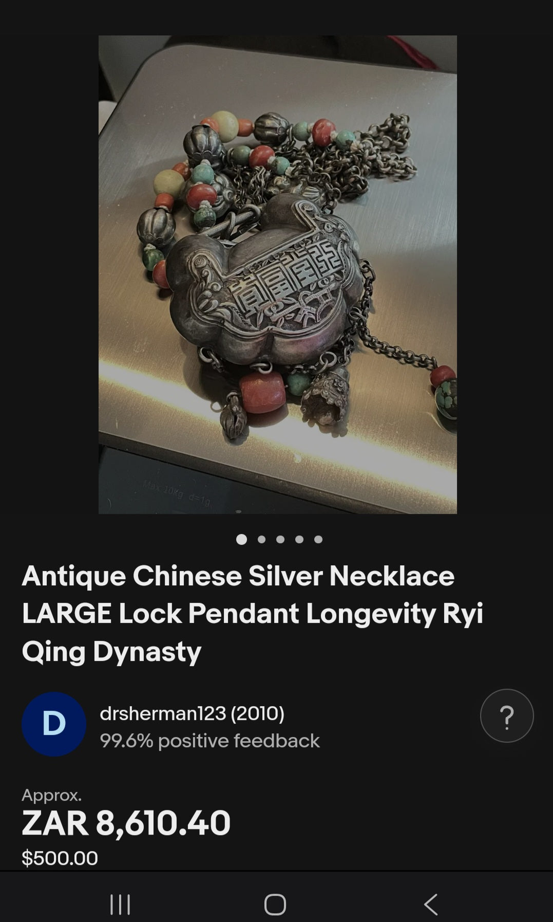 An extraordinary and highly collectible antique Chinese Qing Dynasty sterling silver “Longevity Lock” rattle pendant necklace, lavishly embellished with turquoise and coral bead accents and ornate dangle charms.