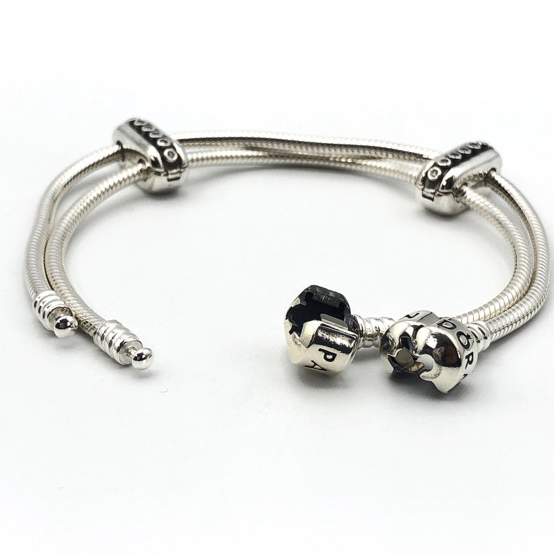 These are a pair of Pandora designer sterling silver bracelet clips "Double Diva", specifically designed to connect multiple bracelets.