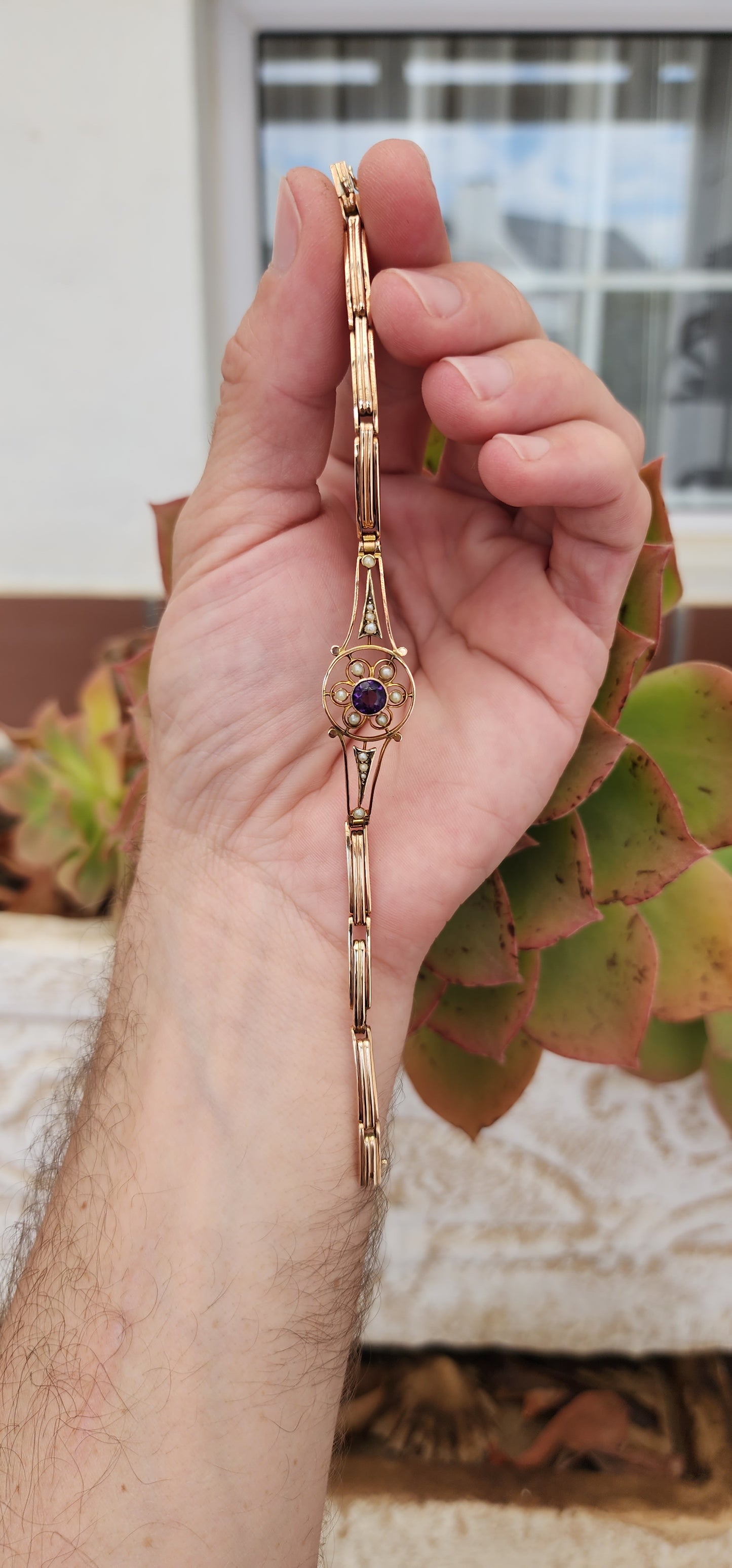 Art Deco era 9ct Rose Gold cocktail bracelet with an central element inlaid flower pattern and set with an Round Cut Amethyst Gemstone and Seed Pearl accents.