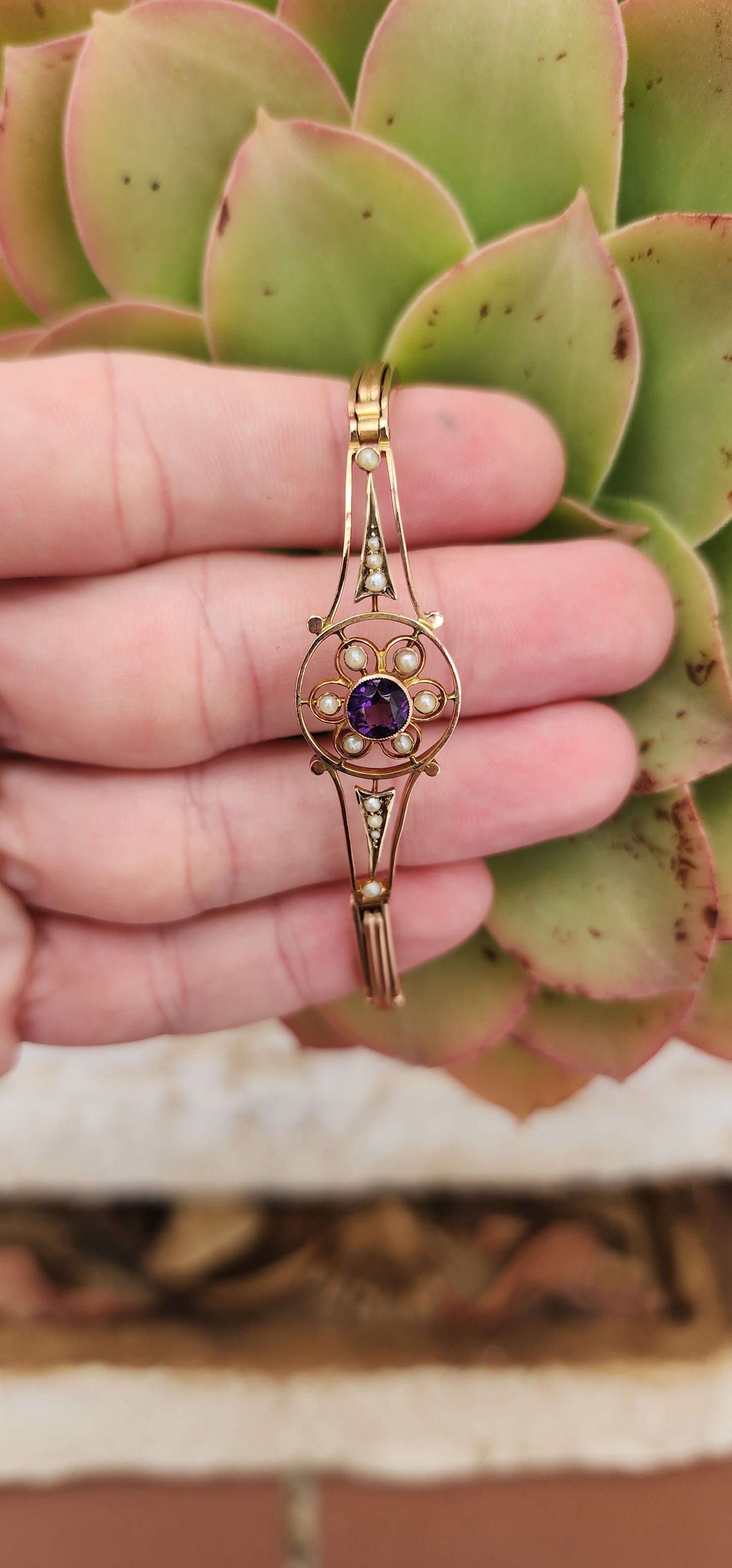 Art Deco era 9ct Rose Gold cocktail bracelet with an central element inlaid flower pattern and set with an Round Cut Amethyst Gemstone and Seed Pearl accents.