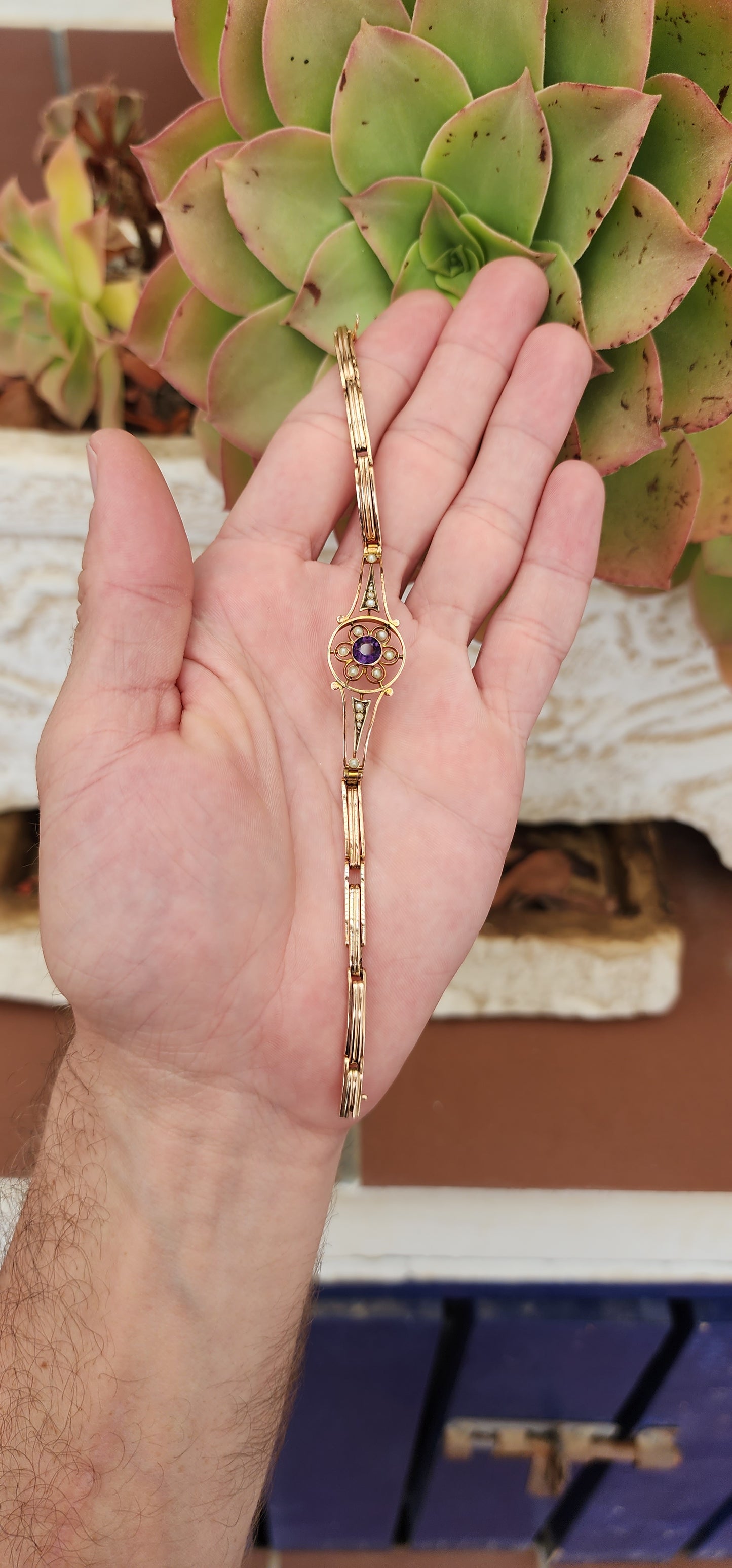 Art Deco era 9ct Rose Gold cocktail bracelet with an central element inlaid flower pattern and set with an Round Cut Amethyst Gemstone and Seed Pearl accents.