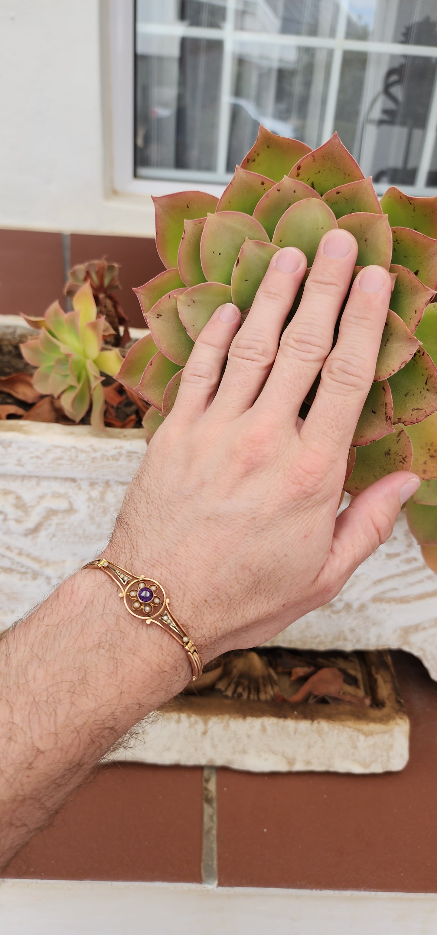 Art Deco era 9ct Rose Gold cocktail bracelet with an central element inlaid flower pattern and set with an Round Cut Amethyst Gemstone and Seed Pearl accents.