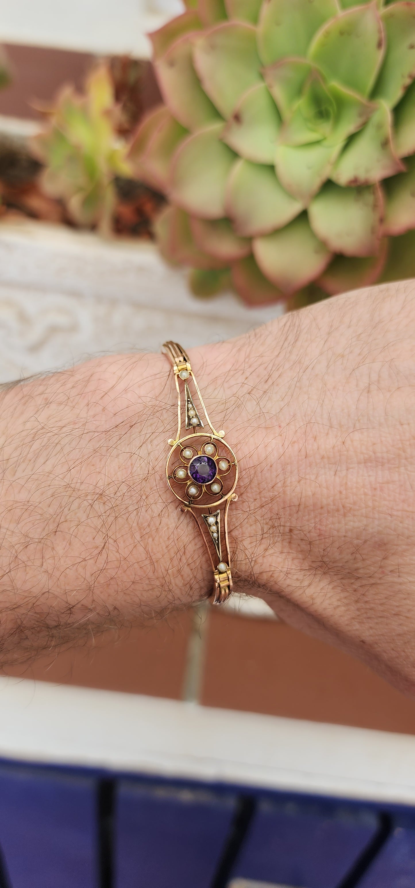 Art Deco era 9ct Rose Gold cocktail bracelet with an central element inlaid flower pattern and set with an Round Cut Amethyst Gemstone and Seed Pearl accents.