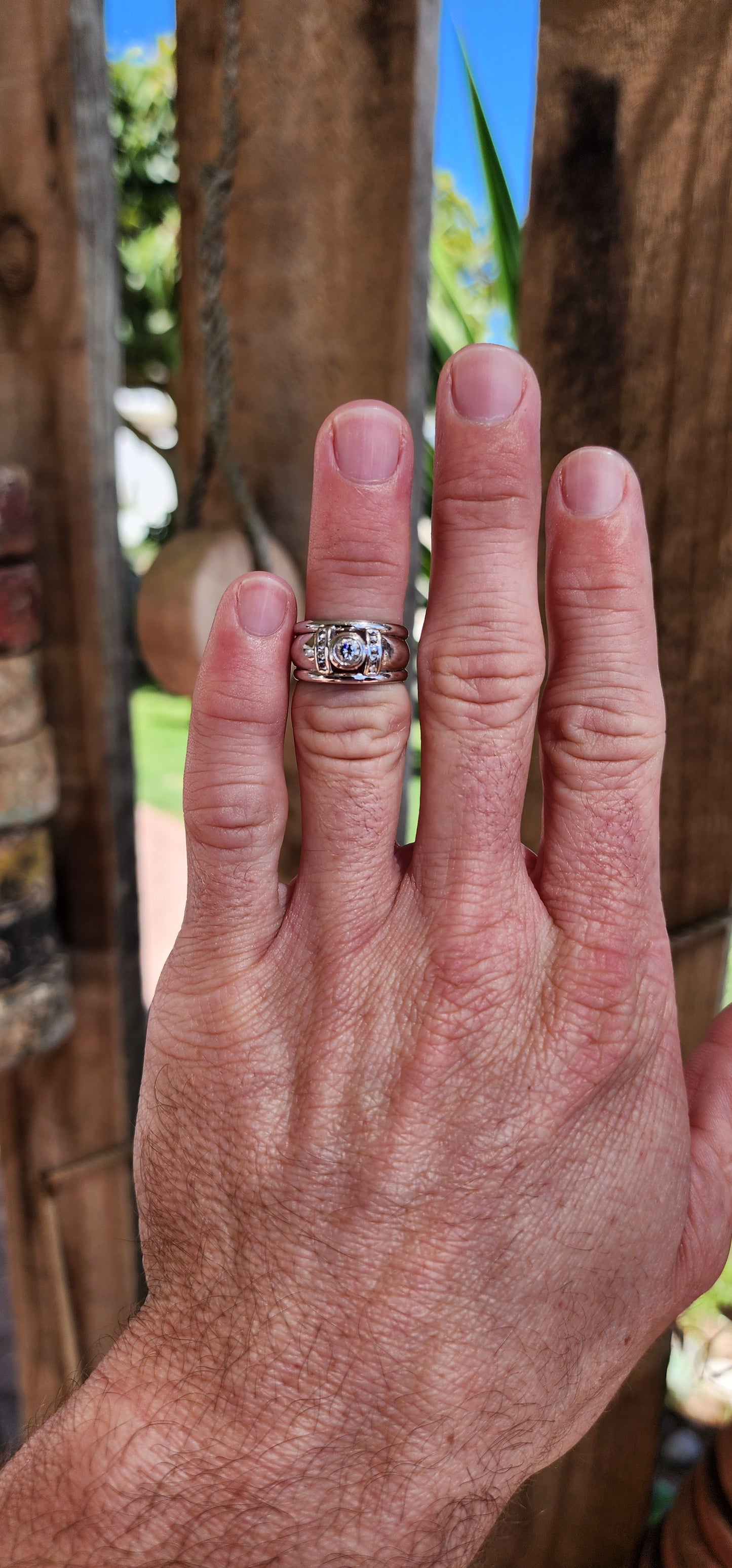 Solid 18ct White Gold dress ring-Bezel set with an generous in size Brilliant Round cut centre Diamond and furthermore channel set with 8x smaller Diamonds.