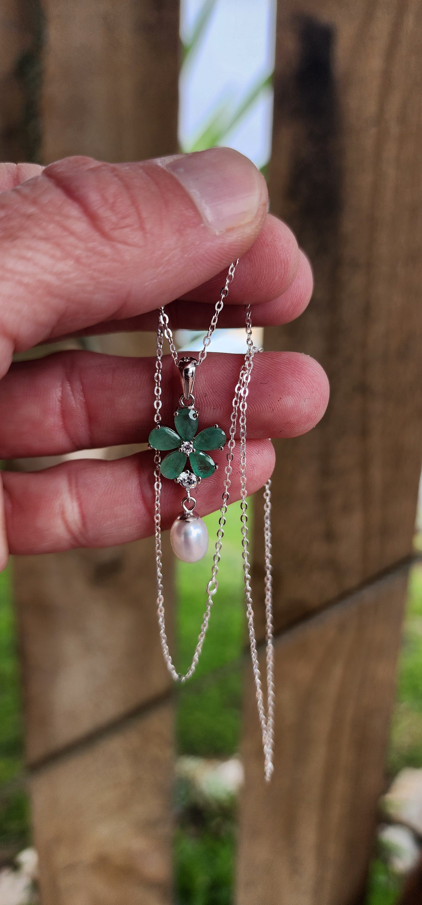 Attractive Sterling Silver ,Natural Emeralds,clear CZ Gemstones and Freshwater Pearl pendant on Sterling Silver chain.