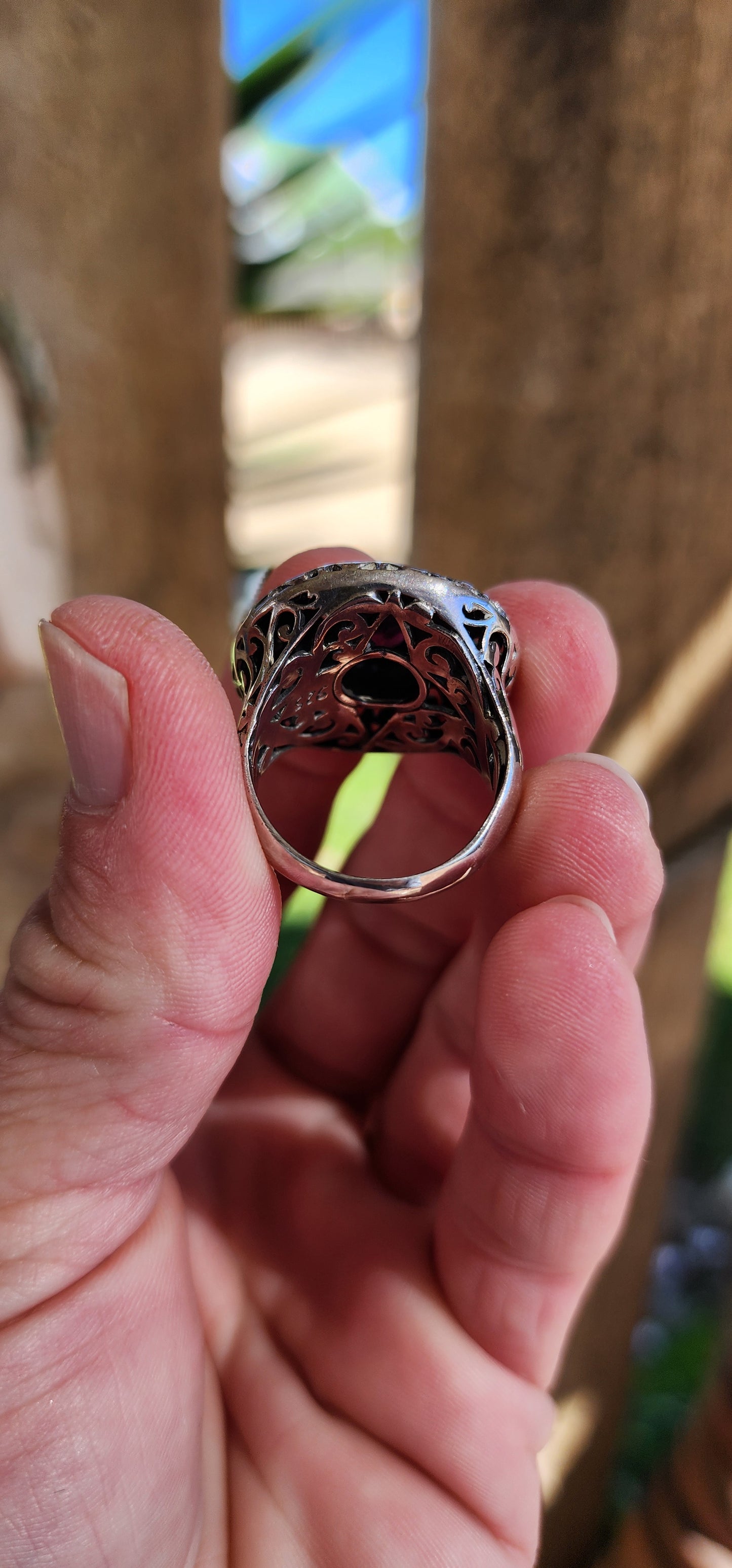 Marvelous and chunky Sterling Silver cocktail/dress ring.An Round cut Amethyst centers the domed design , ornate hand pierced detail spill over from the crown to the shoulders of the band.