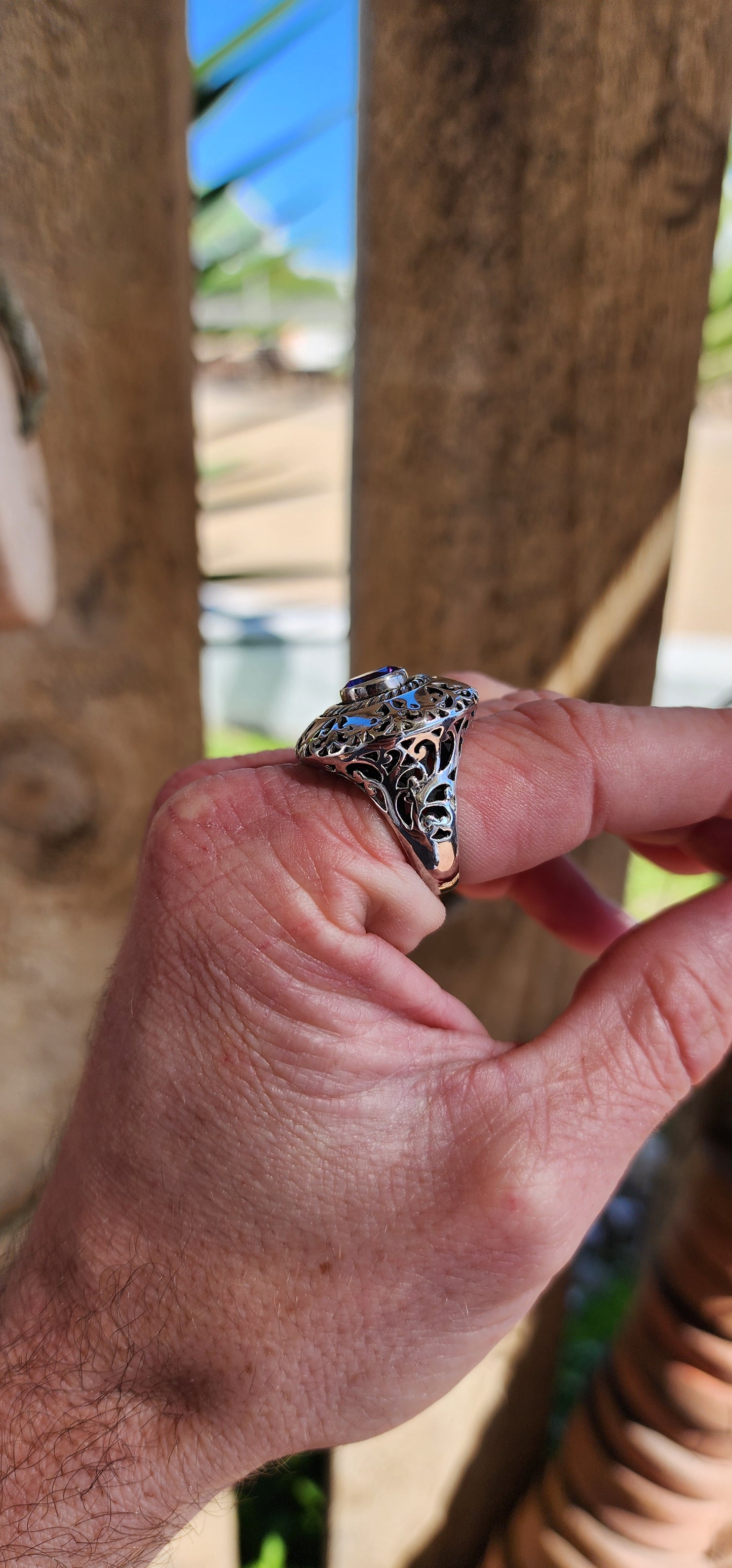 Marvelous and chunky Sterling Silver cocktail/dress ring.An Round cut Amethyst centers the domed design , ornate hand pierced detail spill over from the crown to the shoulders of the band.