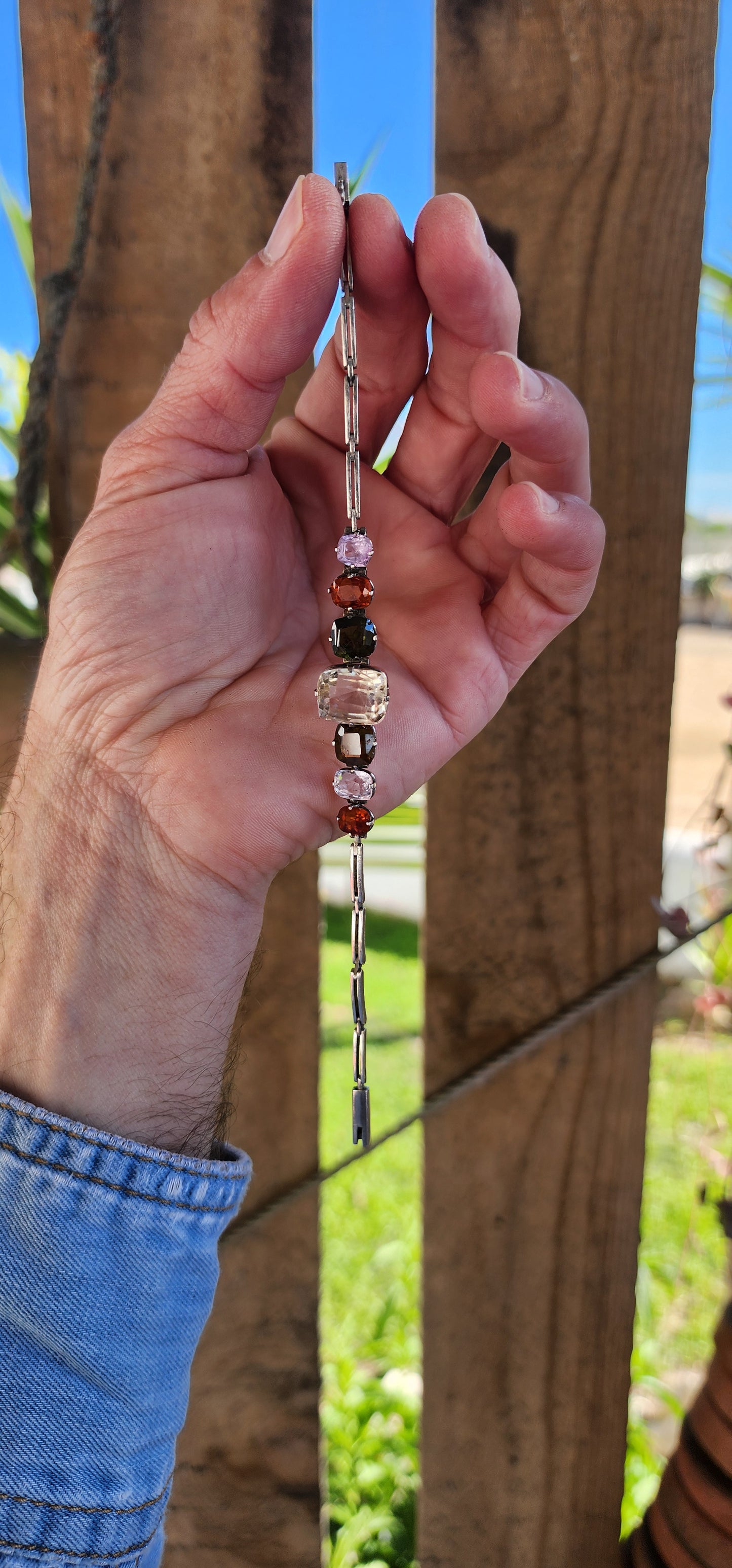 An exceptional Antique Harlequin bracelet set with an Rainbow of Natural Gemstones. Modelled in sterling silver the bracelet has been lovingly hand crafted with hinged links that curve perfectly around your wrist.