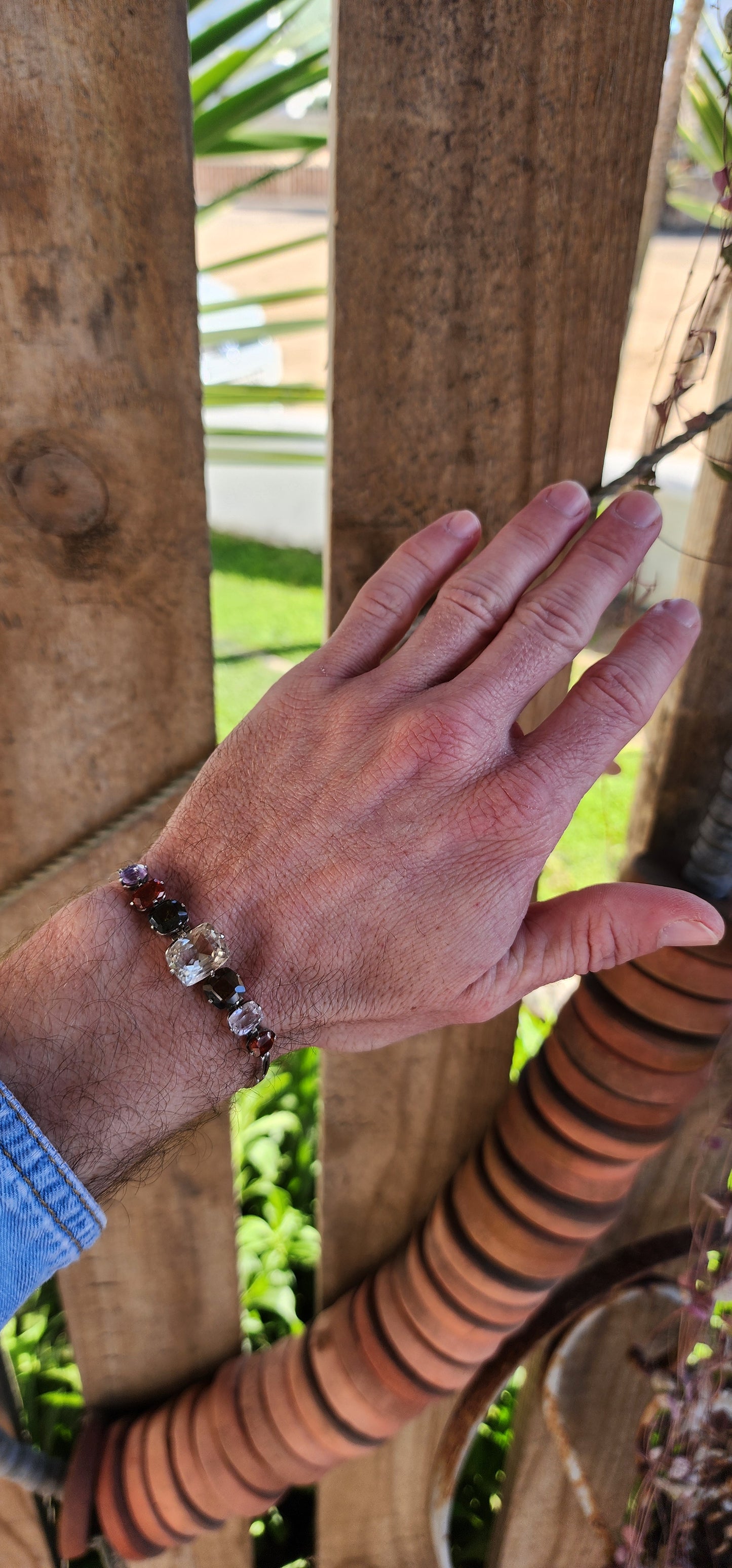 An exceptional Antique Harlequin bracelet set with an Rainbow of Natural Gemstones. Modelled in sterling silver the bracelet has been lovingly hand crafted with hinged links that curve perfectly around your wrist.