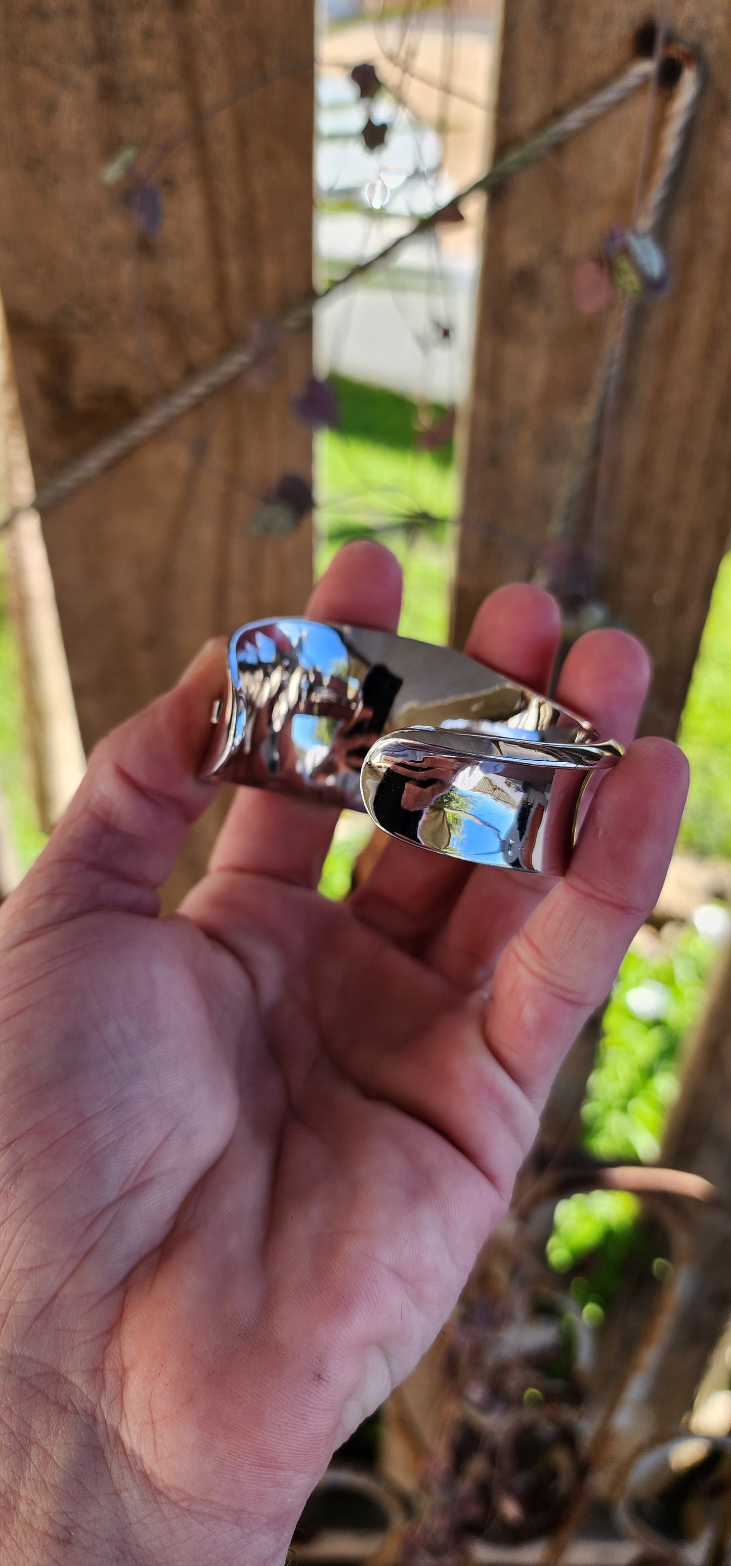 Chunky and weighty Designer Sterling Silver and Ruby Open Cuff STATEMENT bangle with an Modernist Wave design.Accented with an small Ruby at the back.Made by ELLE and signed accordingly.