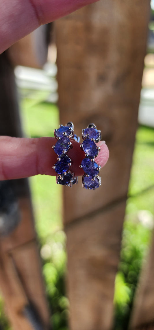 Marvelous pair of Sterling Silver and Tanzanite Gemstones Huggie/Hoop earrings.Each earring claw set with 8x Oval Faceted Cut Tanzanite Gemstones that goes right around .Classical and perfect for day or night wear !