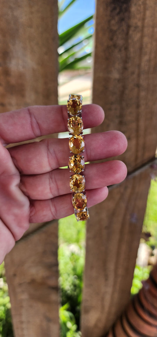 This gorgeous and STATEMENT Tennis style bracelet is crafted in Sterling Silver and features 9x large sized Oval Faceted Cut Yellow Citrine Gemstones.