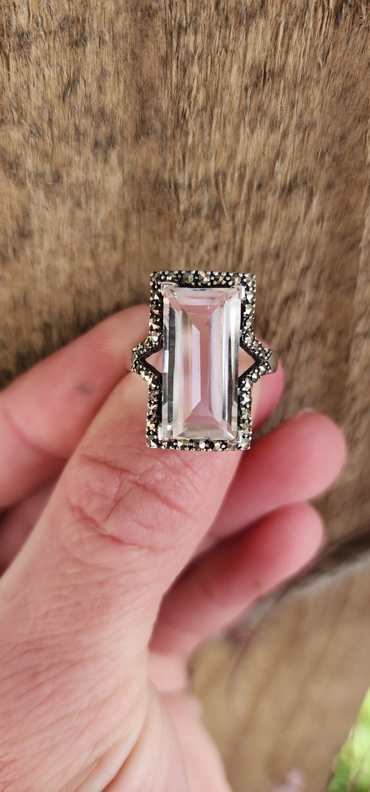 Sterling Silver Art Deco era inspired cocktial ring. This beauty is claw set with an generous in size Rectangular cut White Topaz Gemstone in an Marcasite Haló border.