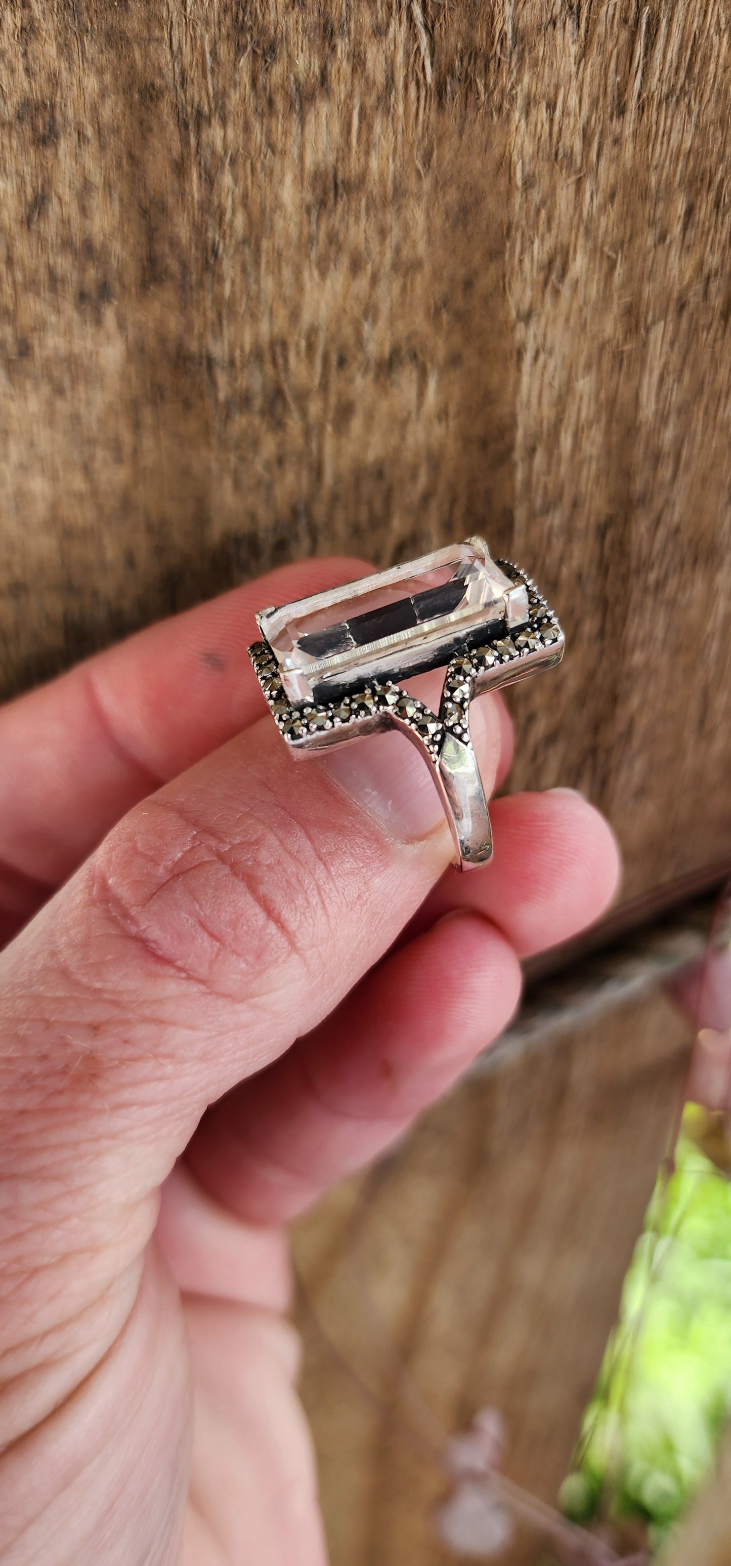 Sterling Silver Art Deco era inspired cocktial ring. This beauty is claw set with an generous in size Rectangular cut White Topaz Gemstone in an Marcasite Haló border.