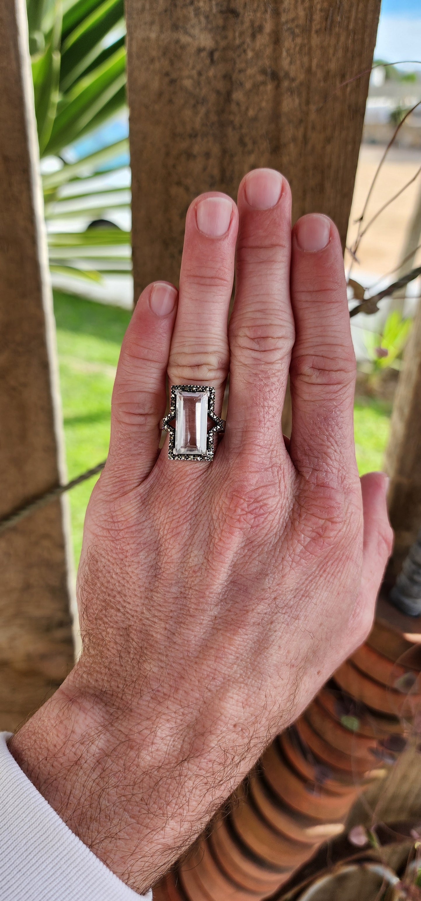 Sterling Silver Art Deco era inspired cocktial ring. This beauty is claw set with an generous in size Rectangular cut White Topaz Gemstone in an Marcasite Haló border.