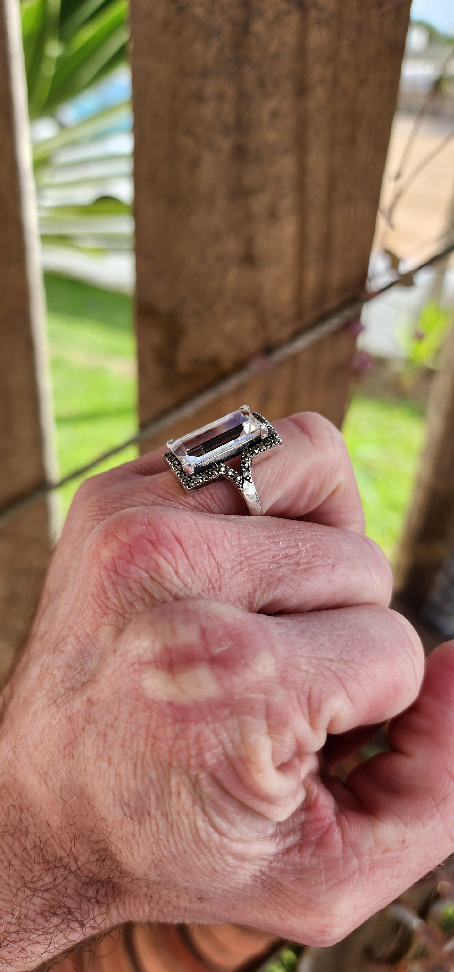 Sterling Silver Art Deco era inspired cocktial ring. This beauty is claw set with an generous in size Rectangular cut White Topaz Gemstone in an Marcasite Haló border.